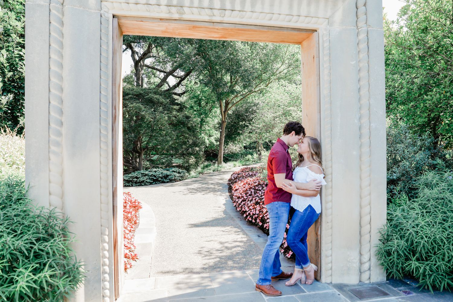 Wide shot of the groom pulling his bride in closer for a very close and intimate pose for their fall engagement session in Dallas Texas.