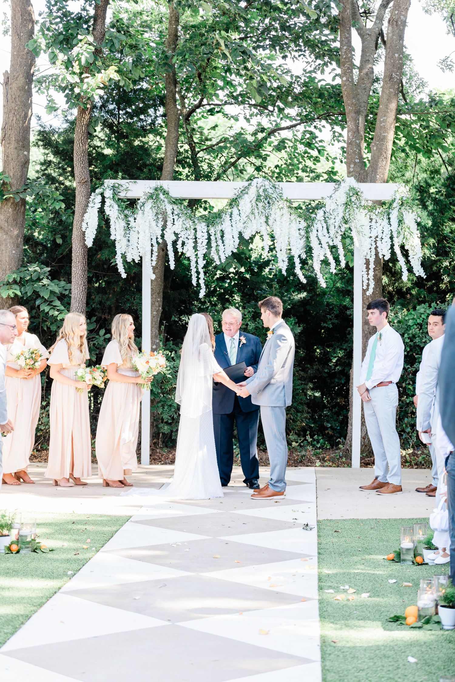 Wide shot of the bride and groom at the alter during the ceremony at the RoseMary Barn.