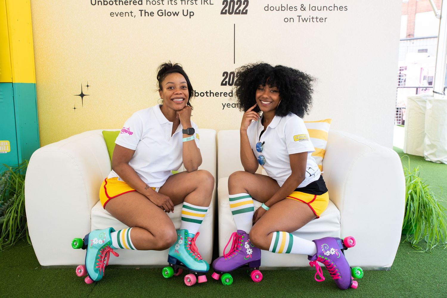 Roller skaters posing against a white wall with colorful artwork.