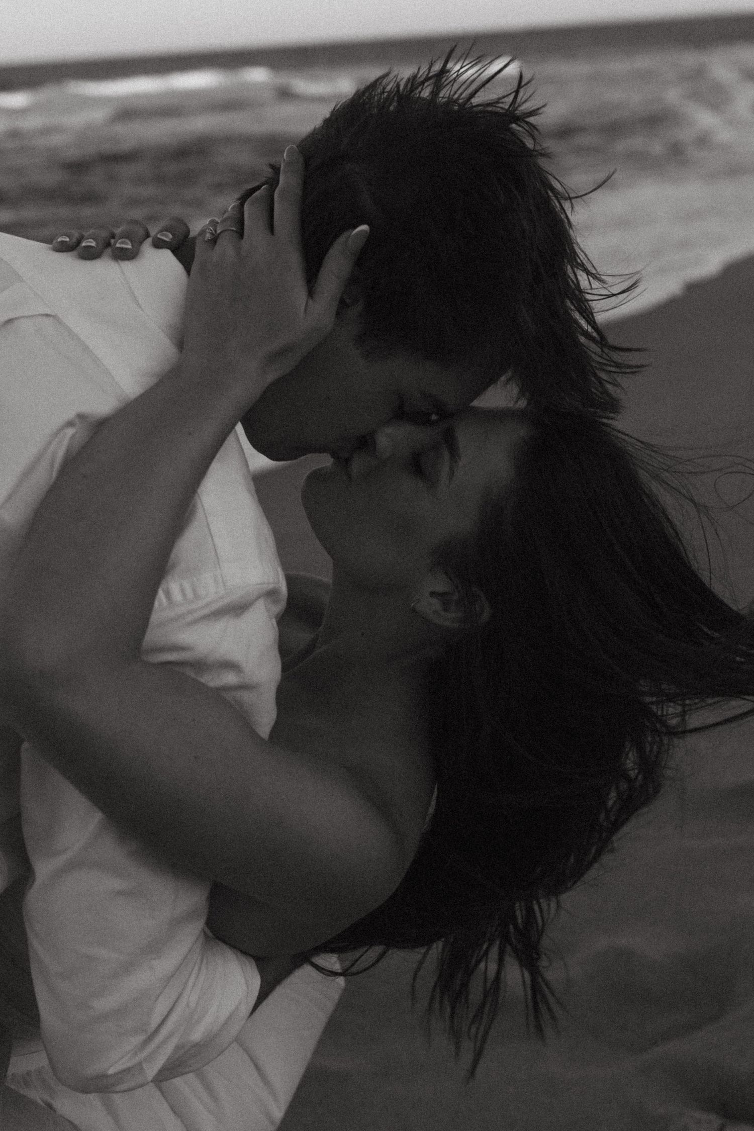 A black and white artistic photo series showing a person with windswept hair in various dramatic poses.