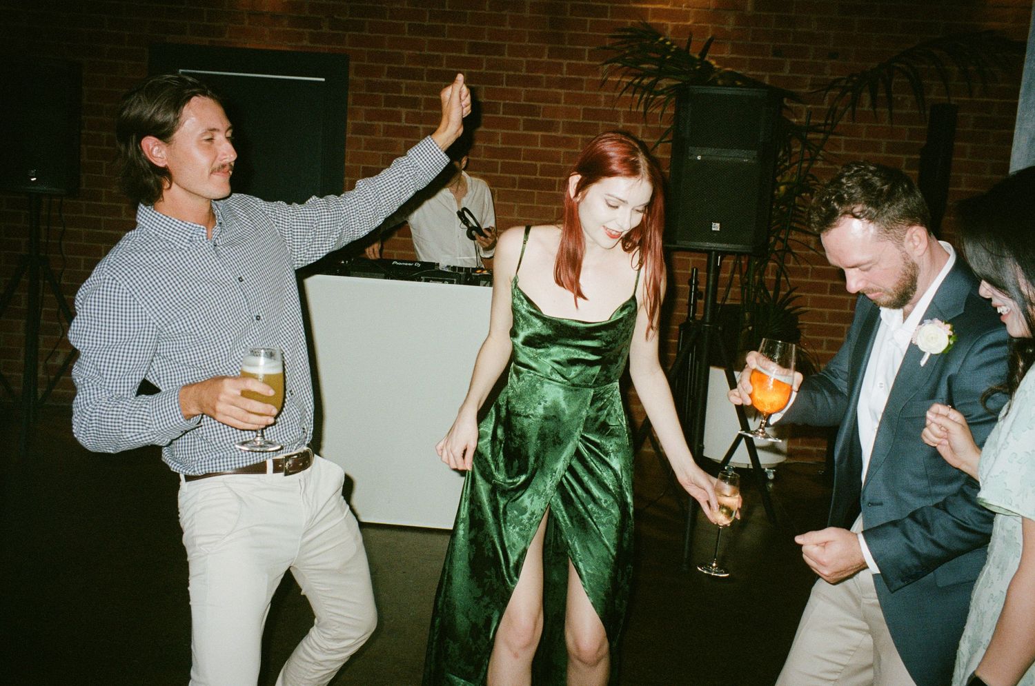 Three partygoers dancing and having fun at a festive event.
