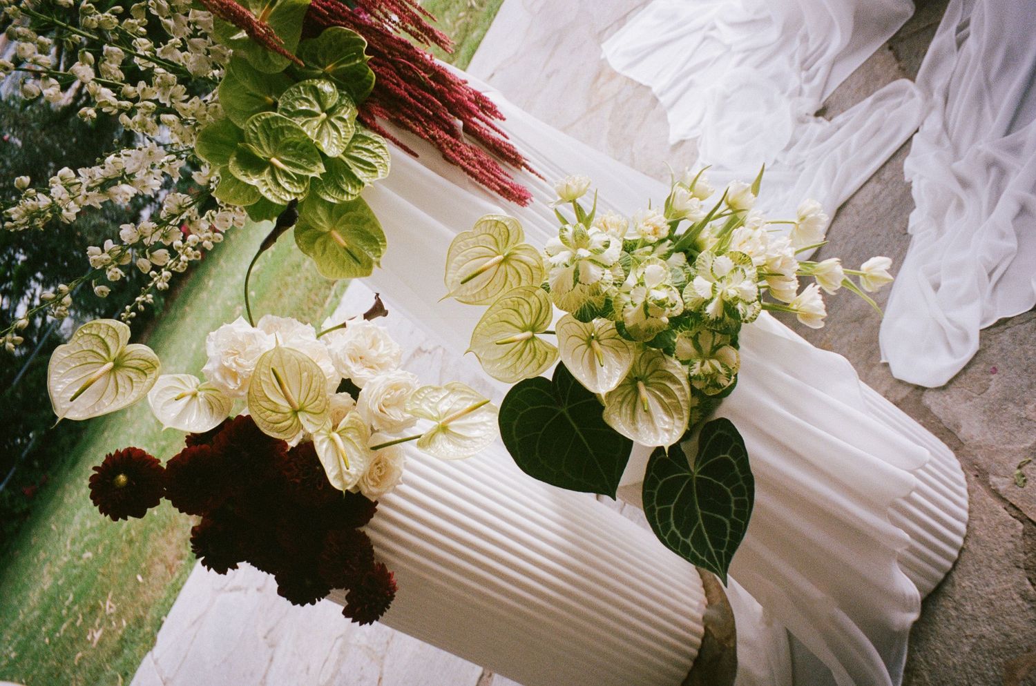 White flower bouquets and delicate floral arrangements against a soft, textured background.