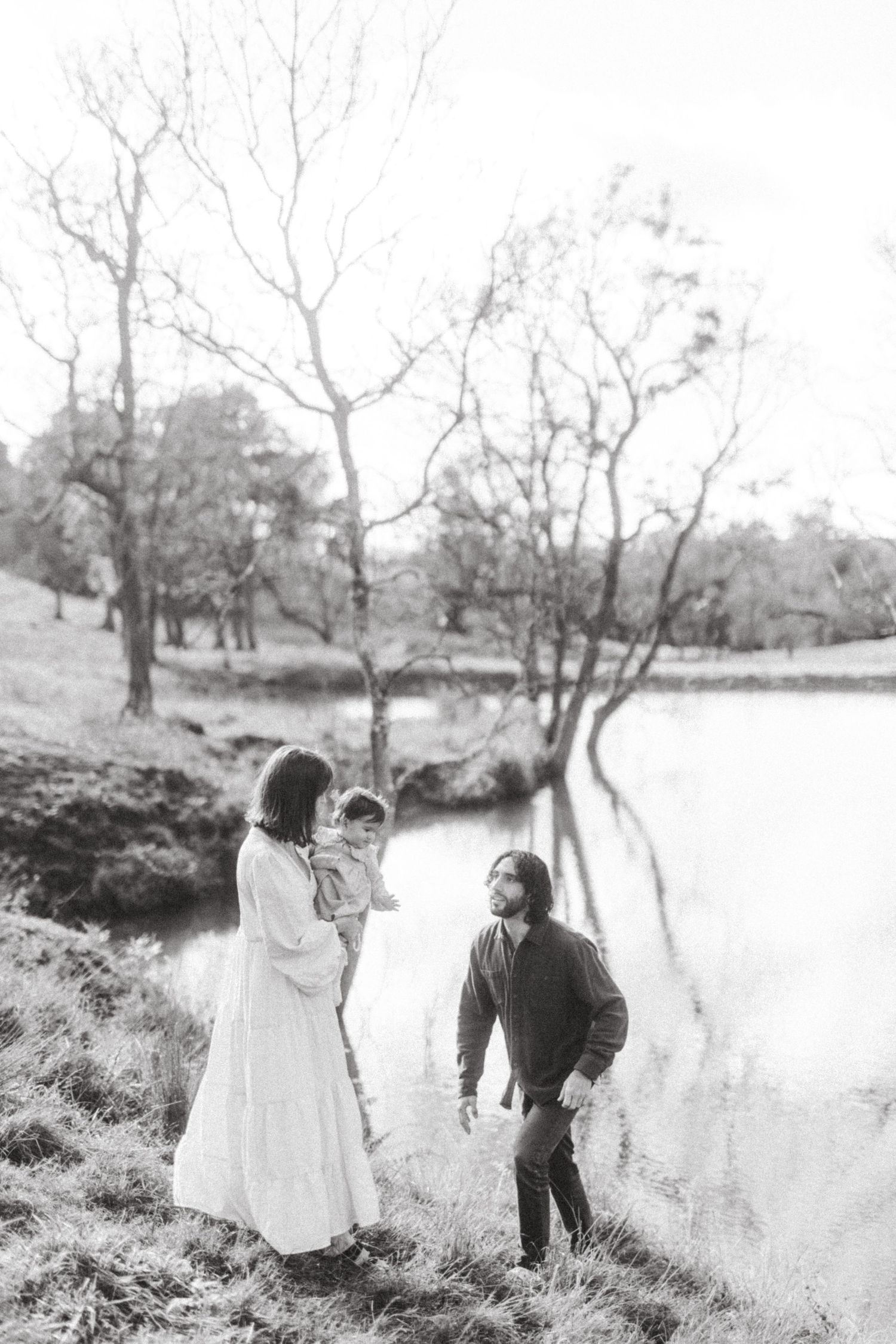 A series of black and white photographs showing two people enjoying a peaceful moment by a tranquil lake.