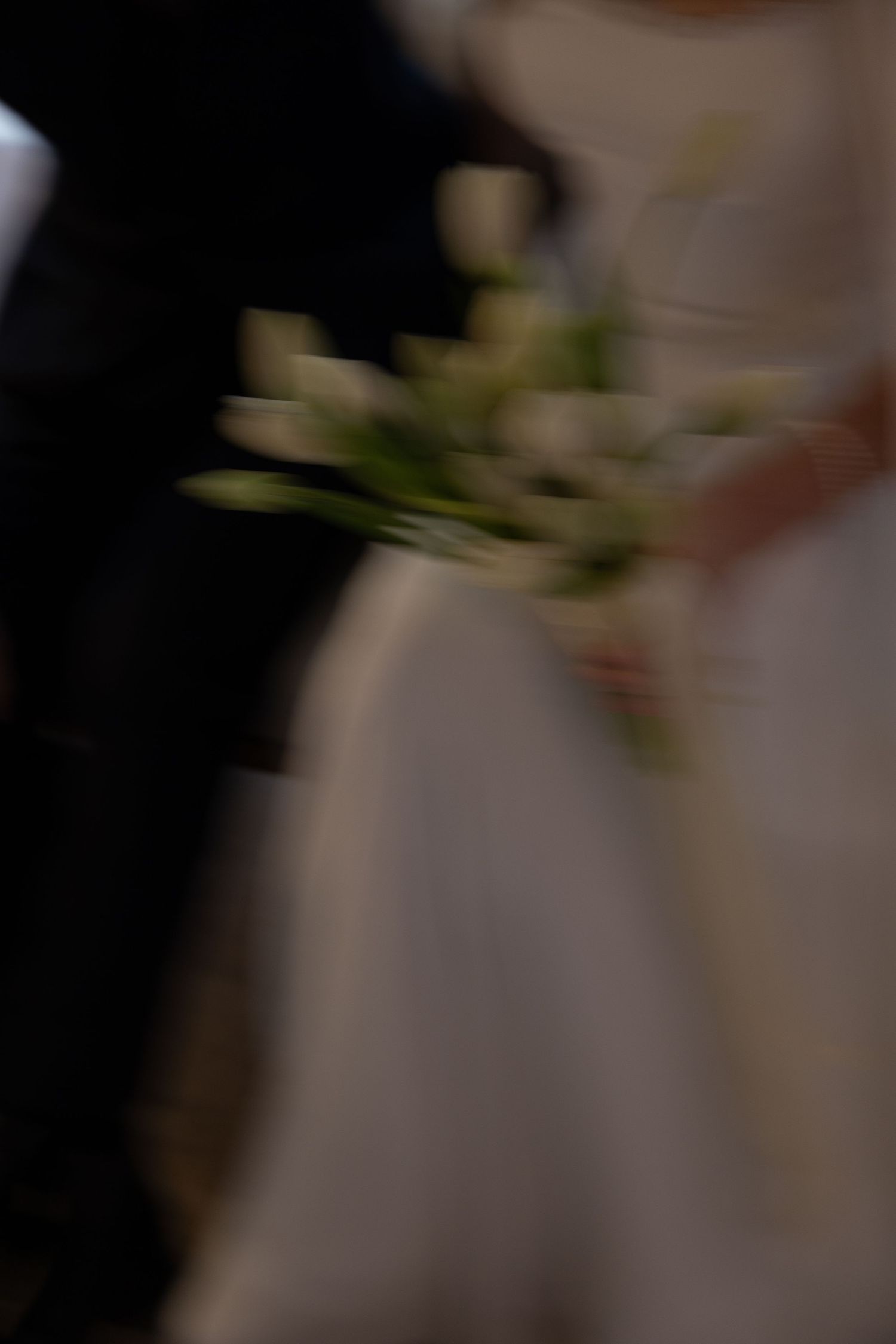 A row of beautiful white lily flowers in soft focus with blurred background creates an elegant bokeh effect.