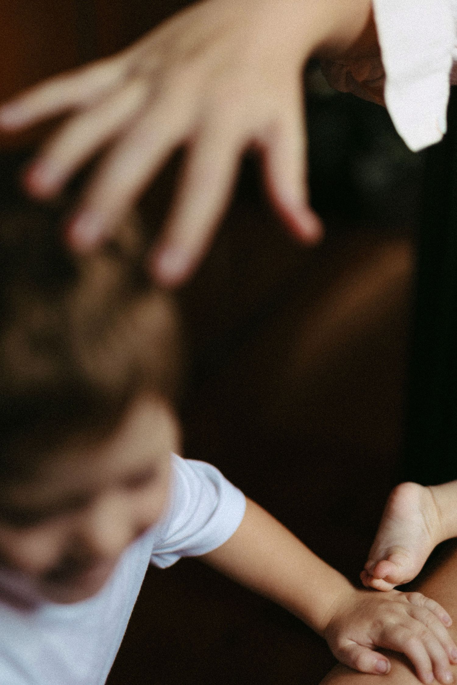 Artistic close-up shot of hands reaching out in soft focus.
