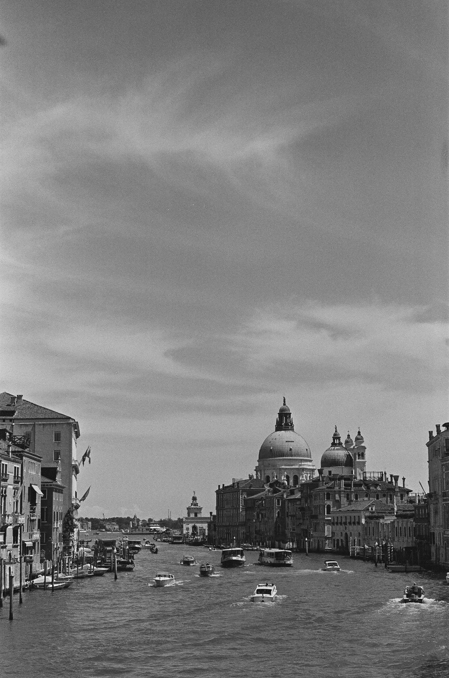 Grand Canal of Venice with Santa Maria della Salute dome and boats in the distance.