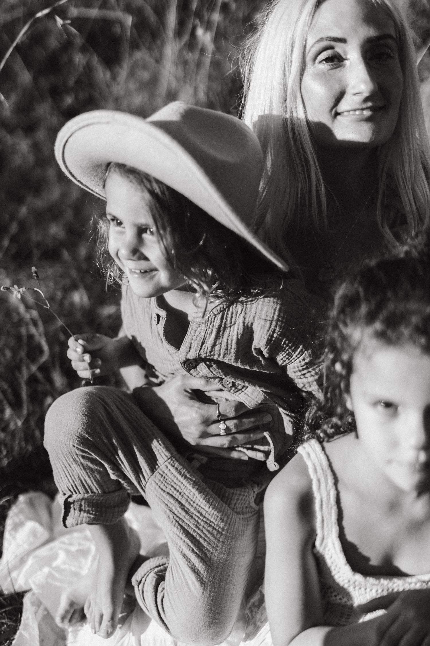 Black and white candid photo sequence showing people in casual western attire enjoying a sunny outdoor moment.