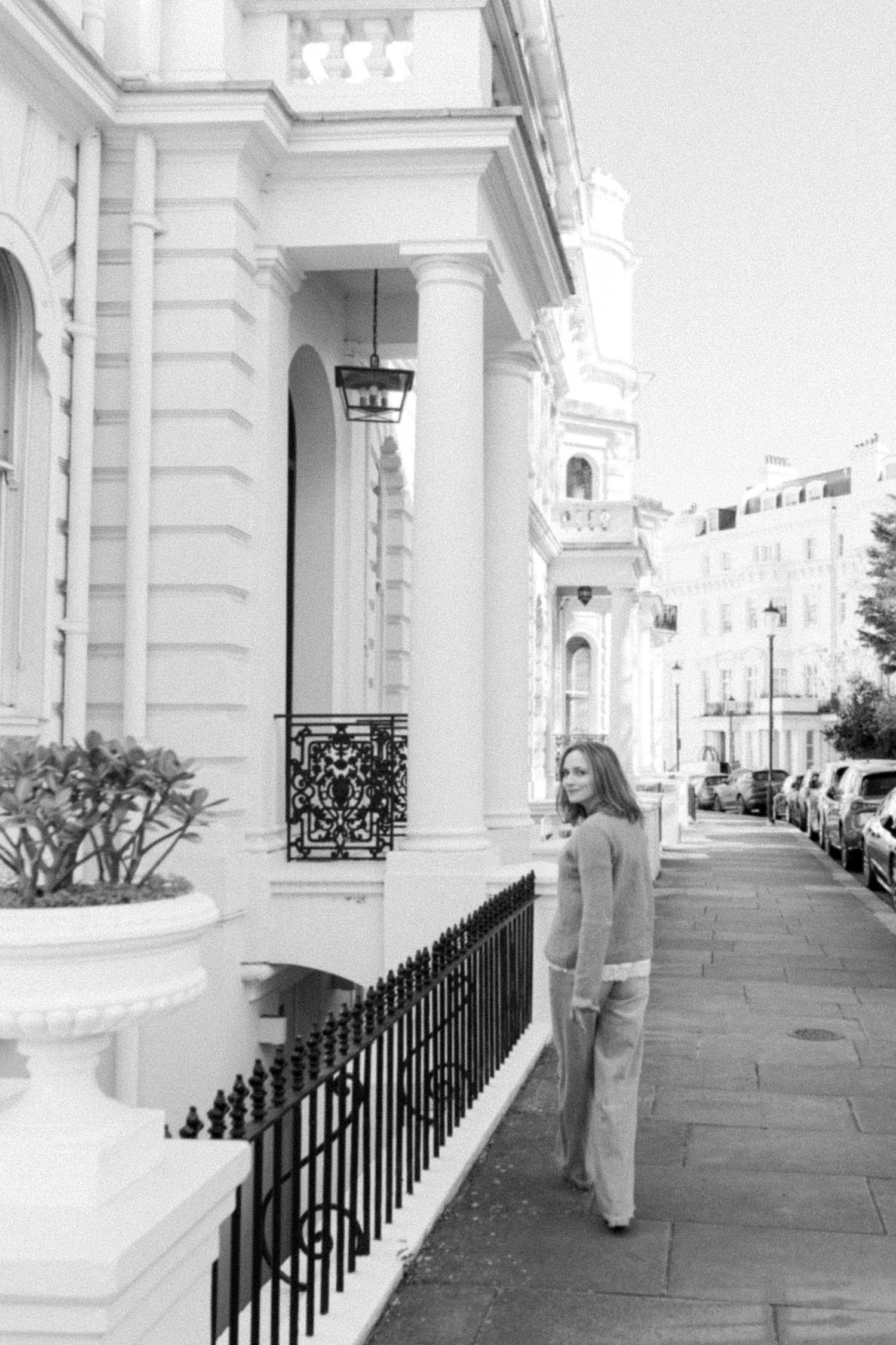 Black and White film photo of Miriam Caterina Wahl walking through a georgian street in London