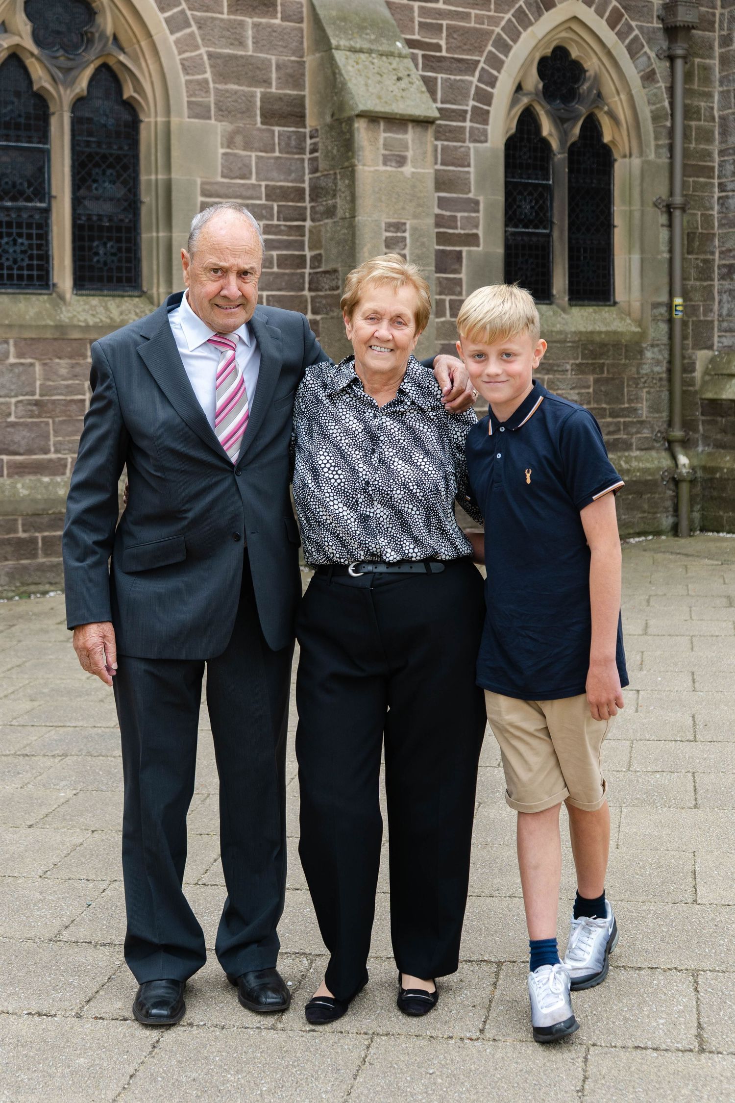 Group photos taken outside a stone church building.