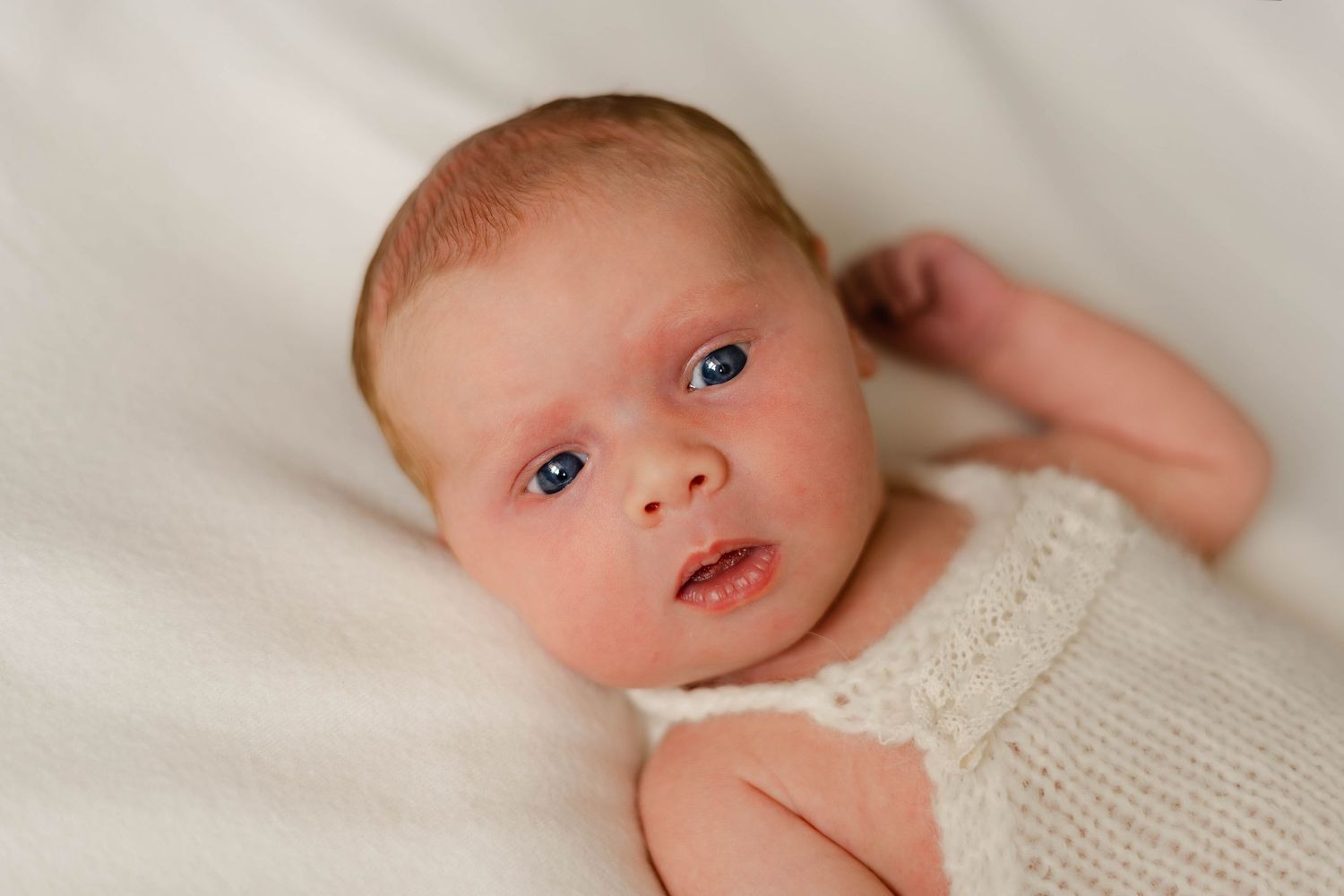 Close-up newborn photography series showing baby details in soft lighting.