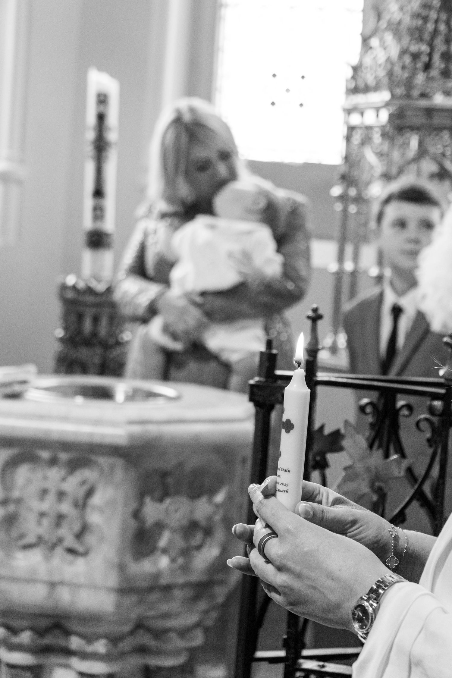Black and white photo showing hands raised during a wedding ceremony.