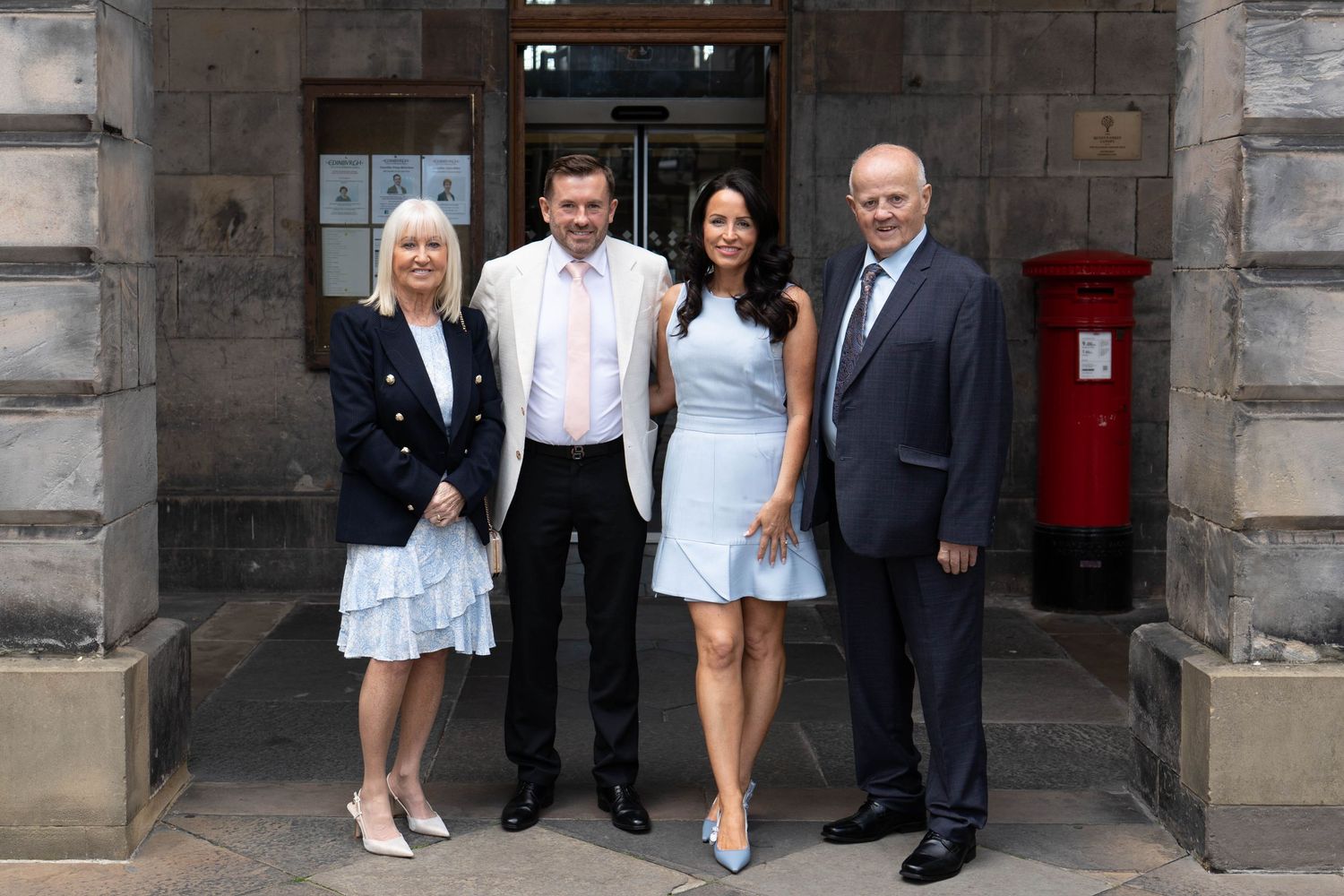 Wedding party members gathered at City Chambers entrance for formal photo.