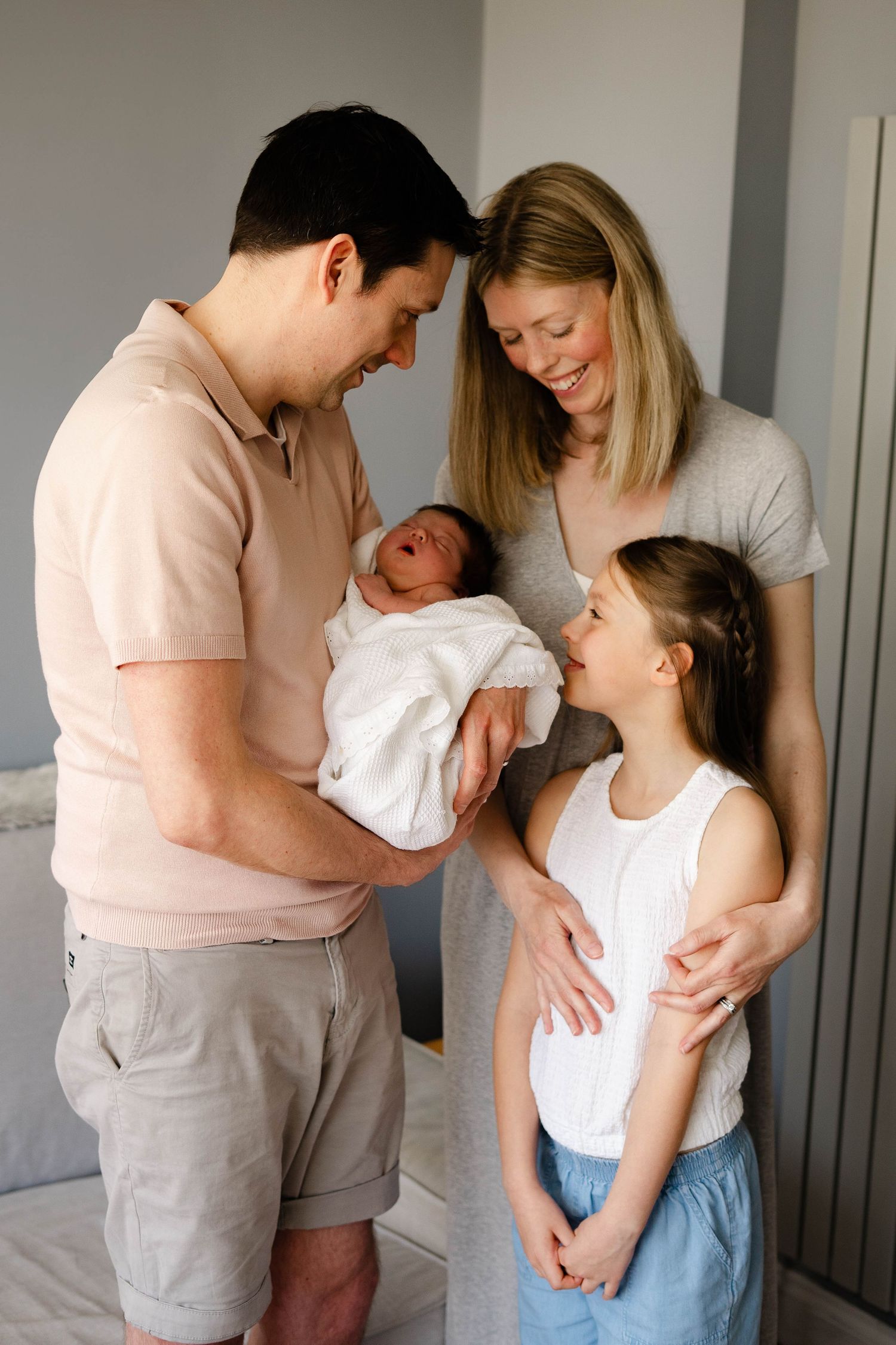 Candid family lifestyle session showing joyful interactions with newborn baby.