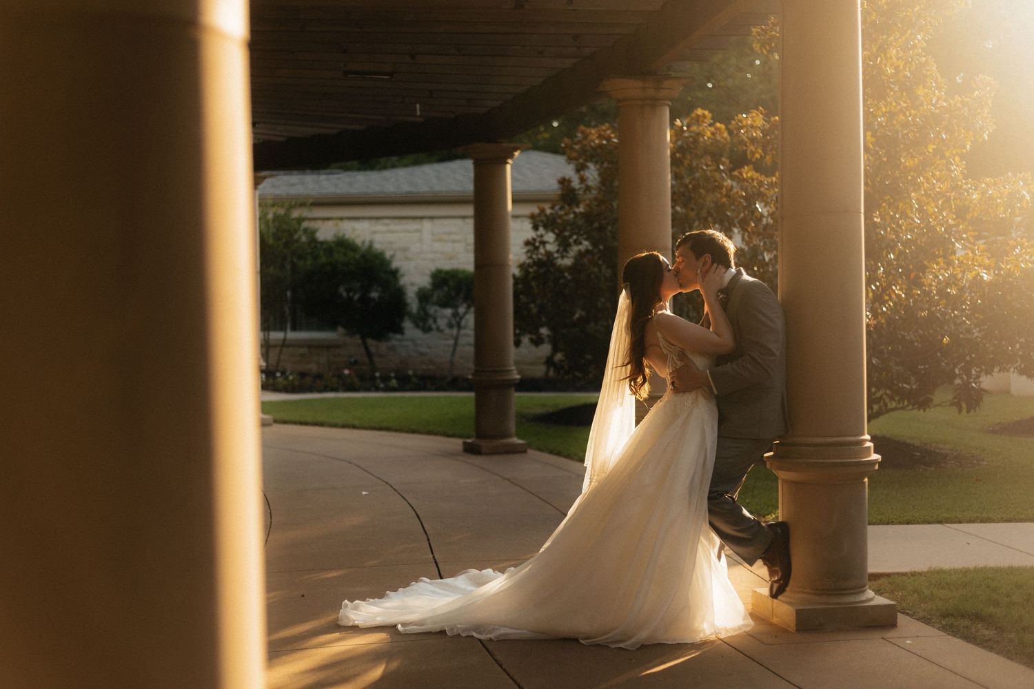 Sunset streaming through columns creates dramatic silhouettes in an outdoor setting.