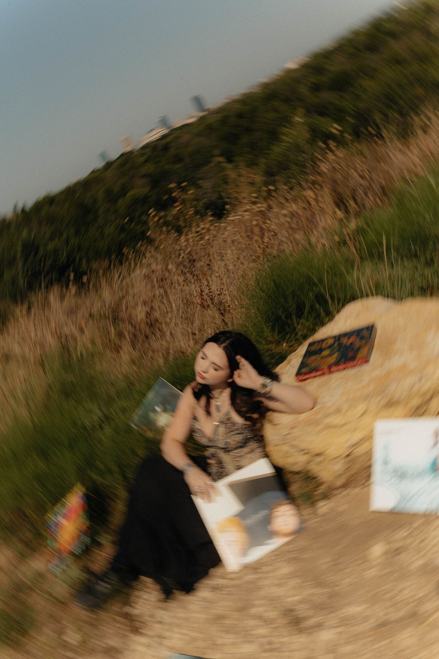 Blurred motion shot of person rolling on blanket in outdoor setting.