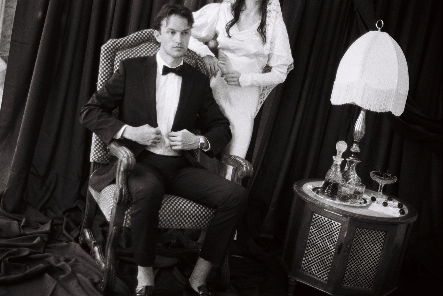 A collection of black and white photos showing people in formal attire at various social gatherings and events.