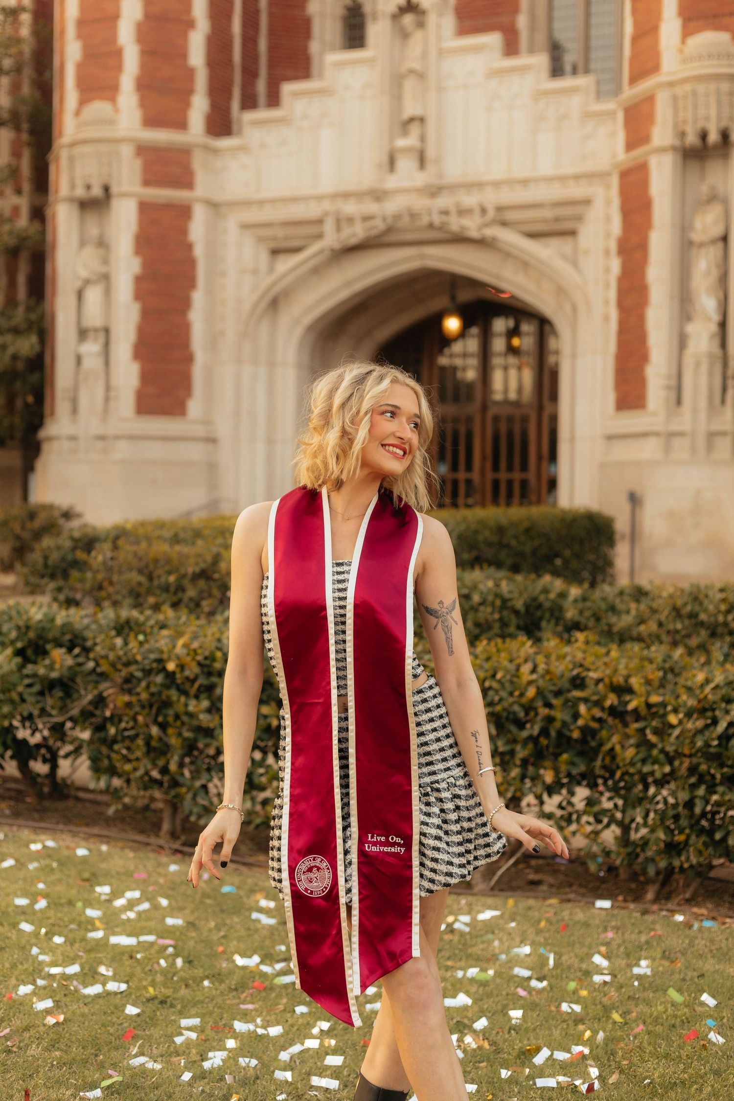 Graduation celebration photos with a red stole in front of a historic brick building.