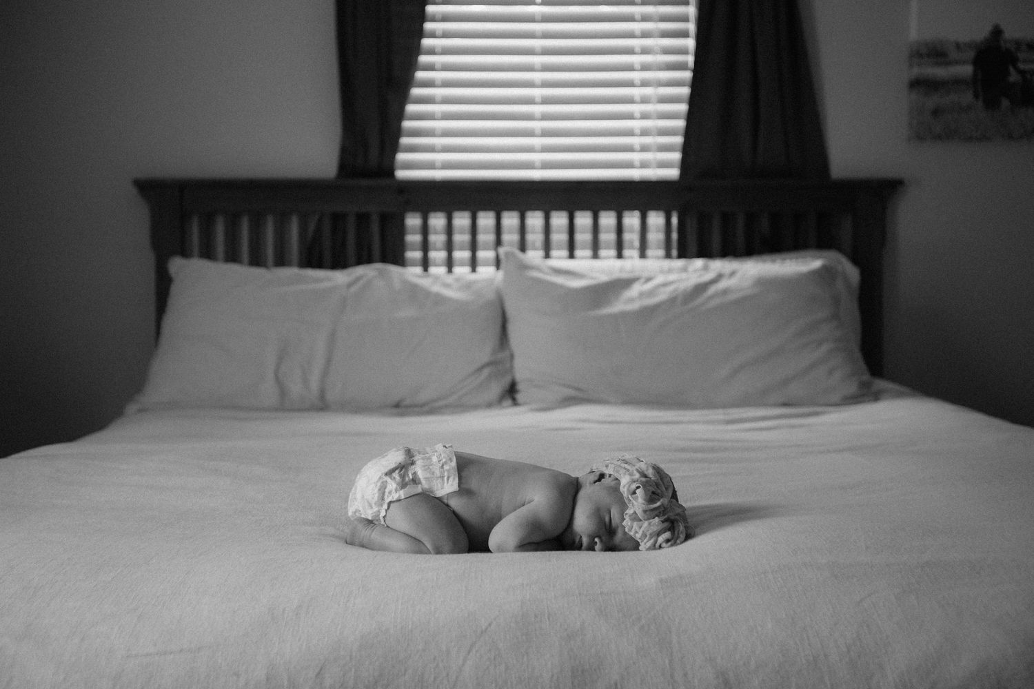 A peaceful sequence of a sleeping cat curled up on a cozy white bed.