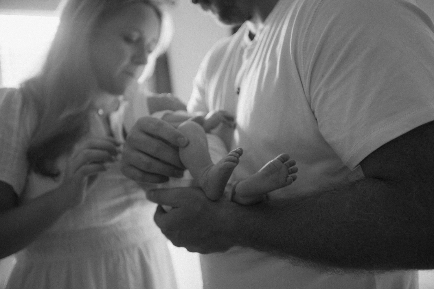 Intimate black and white photos of couple in tender moments.