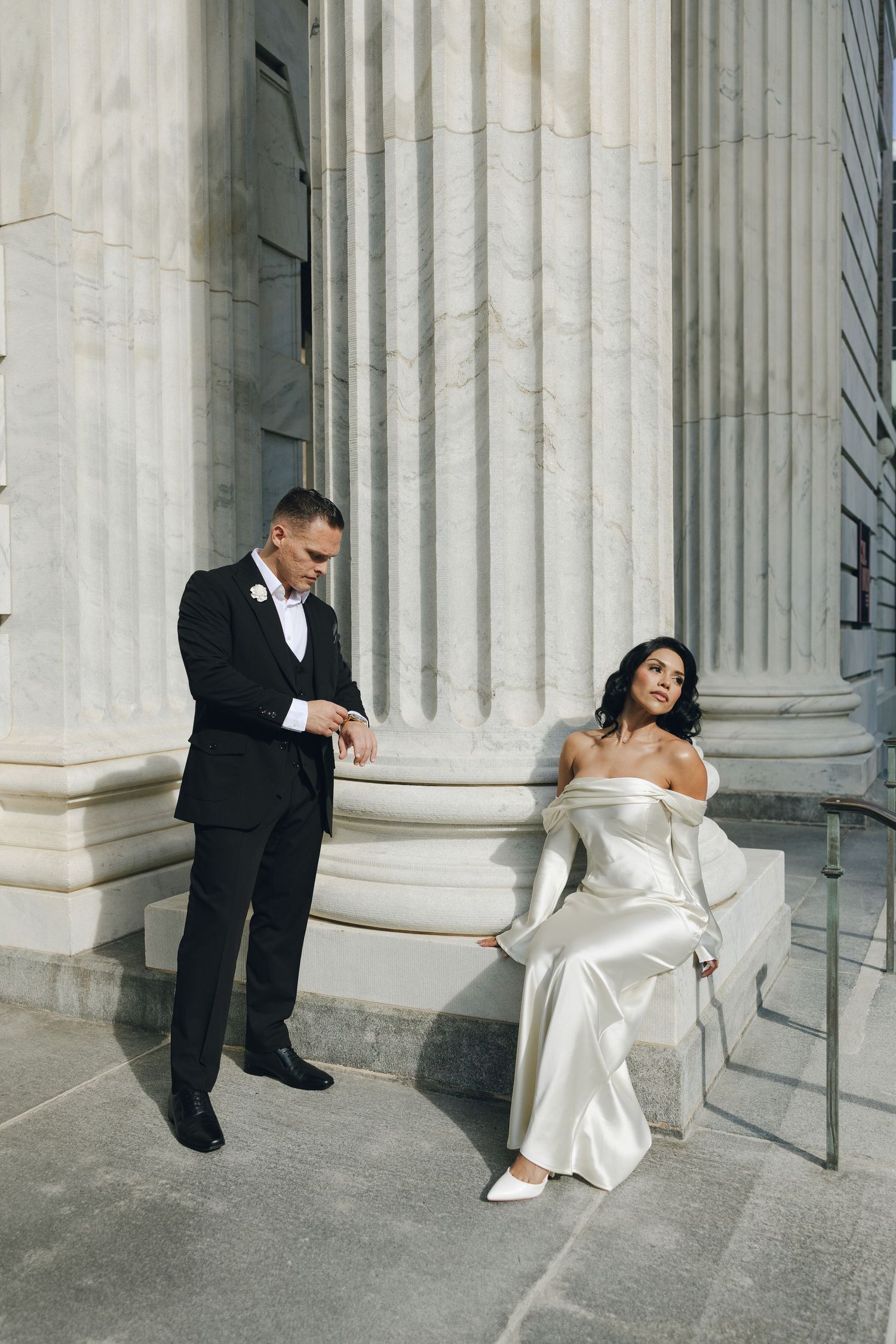 A wedding couple poses playfully in a sequence of four artistic shots against classic white marble columns.