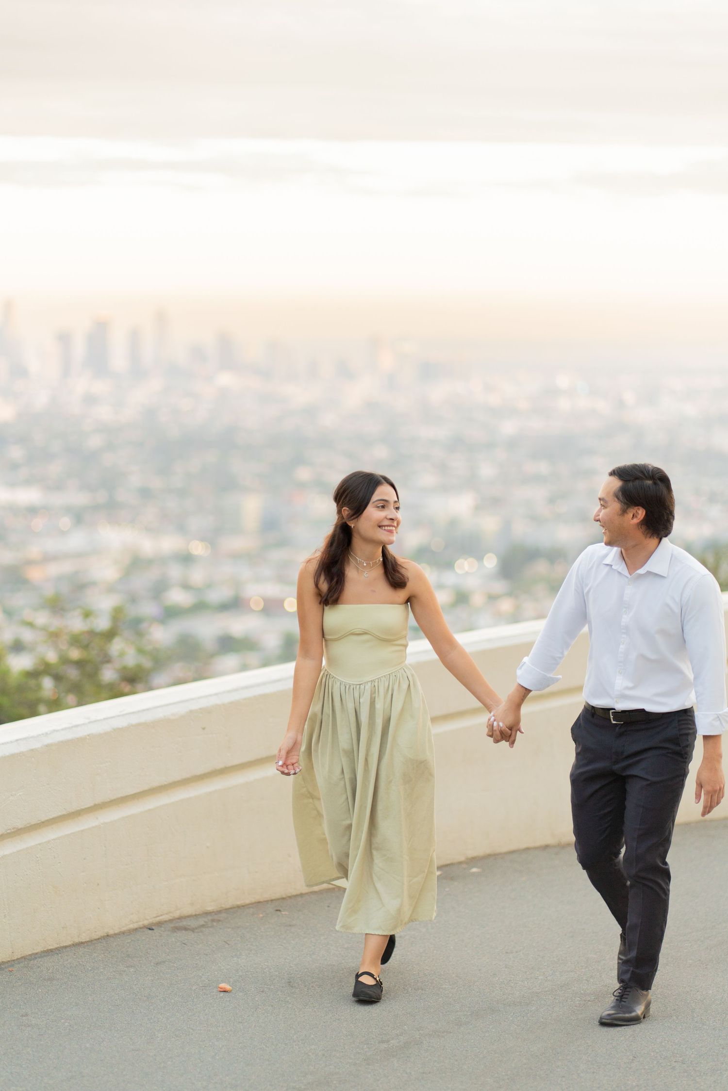 Two couples enjoying a relaxed stroll through Griffith Park, surrounded by nature and scenic views.