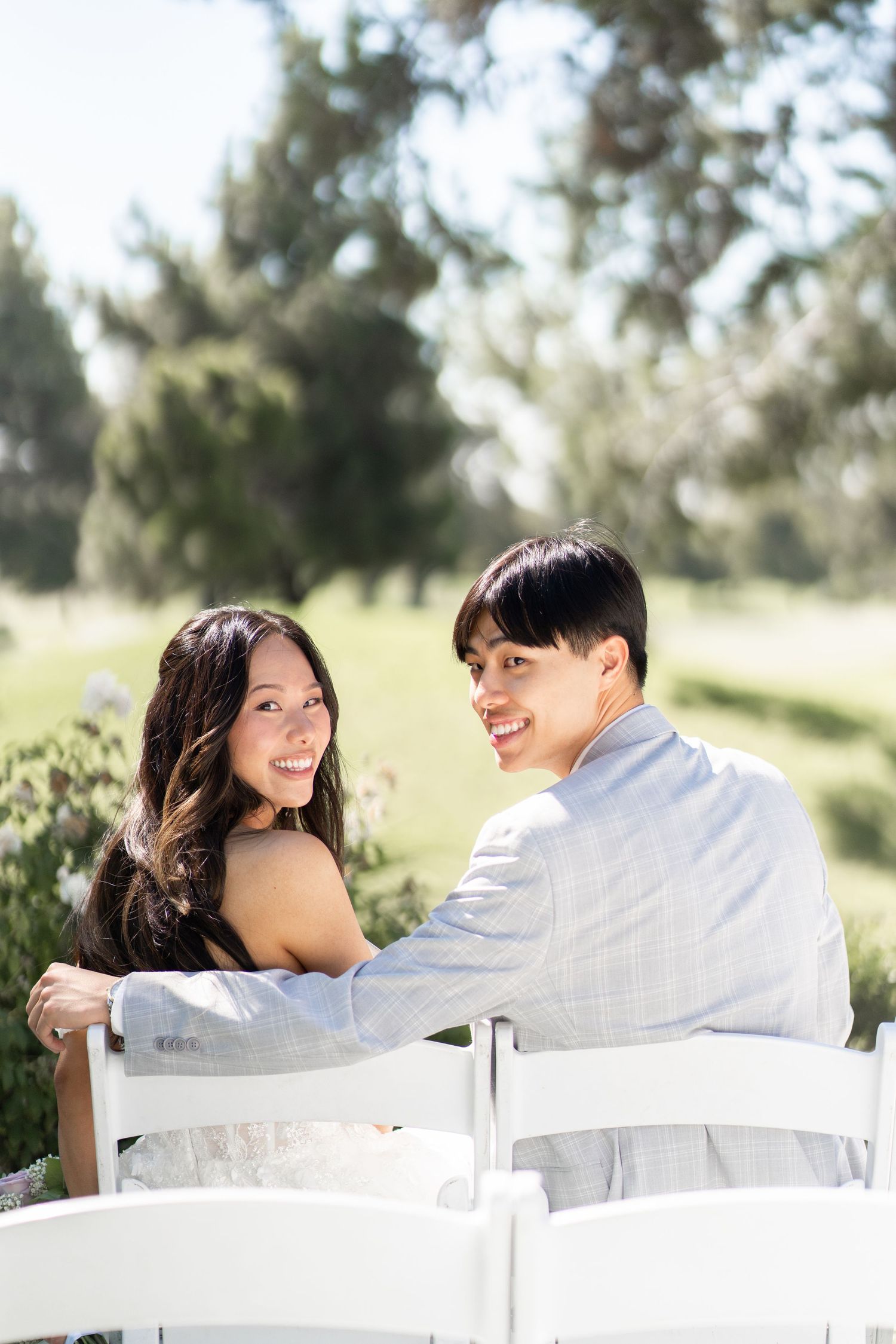Bride and groom capturing sweet moments in photos before the ceremony begins.