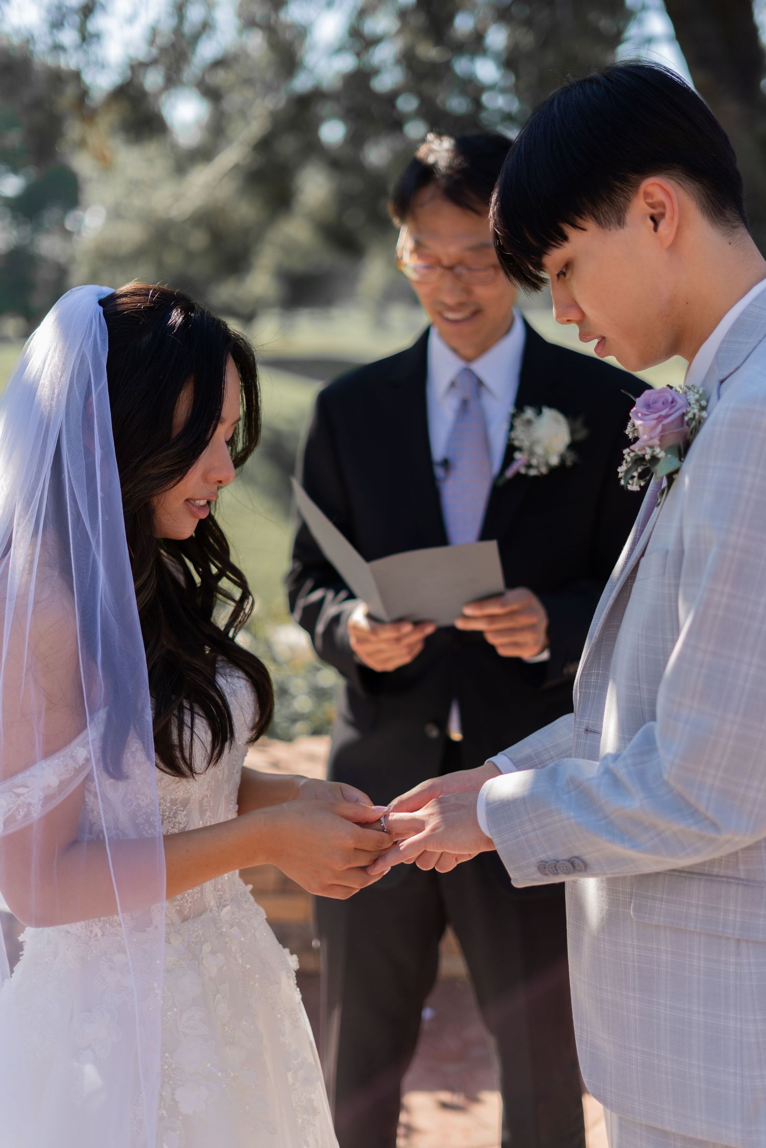 Bride and groom exchanging rings, a beautiful moment in their wedding ceremony.