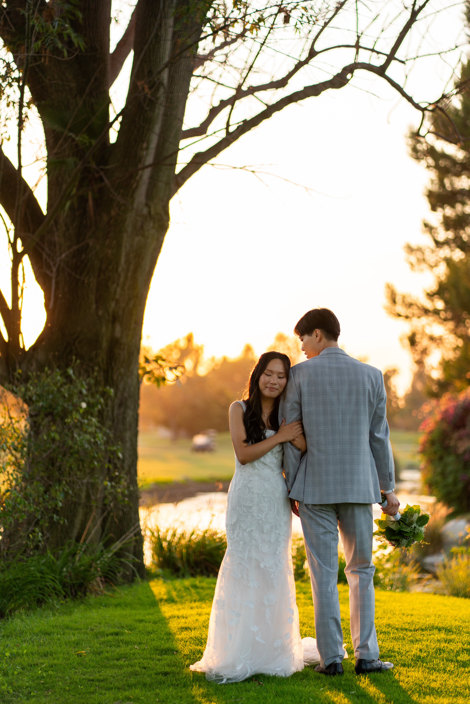Bride and groom sharing a romantic couples photoshoot under a golden sunset.