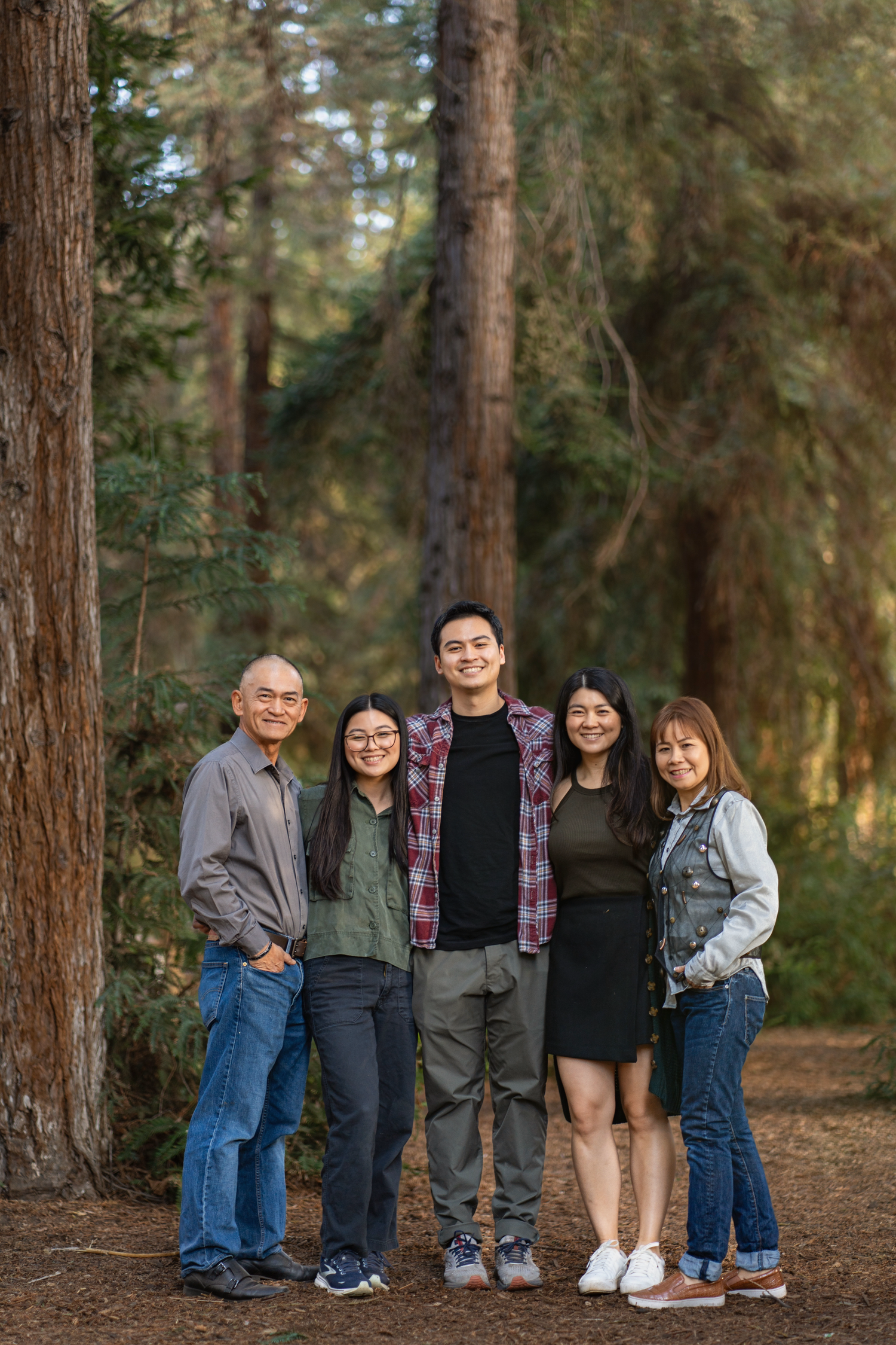 Family smiles together in front of a beautiful tree, making memories surrounded by nature’s beauty. #FamilyMoments #ParkPhotos #NatureLove