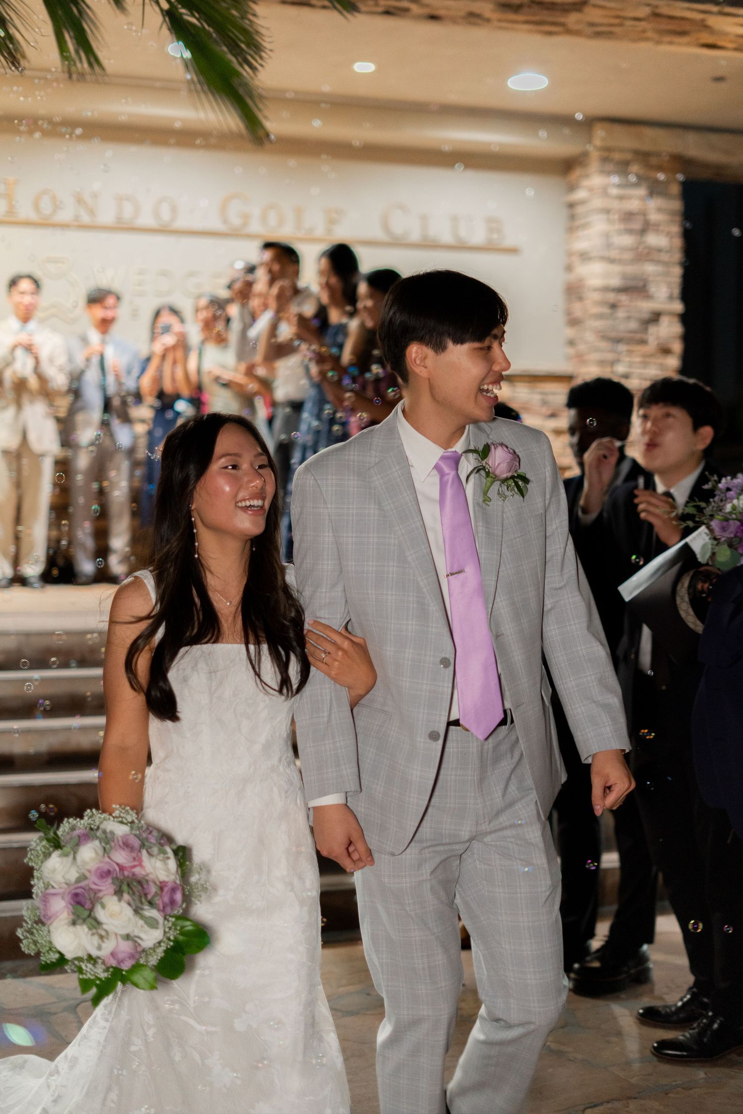 Bride and groom exit the ceremony, surrounded by love and blessings from friends and family.