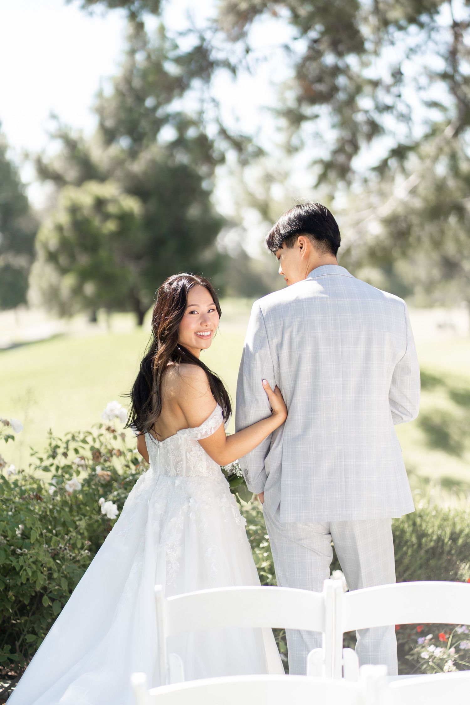 Bride and groom capturing sweet moments in photos before the ceremony begins.