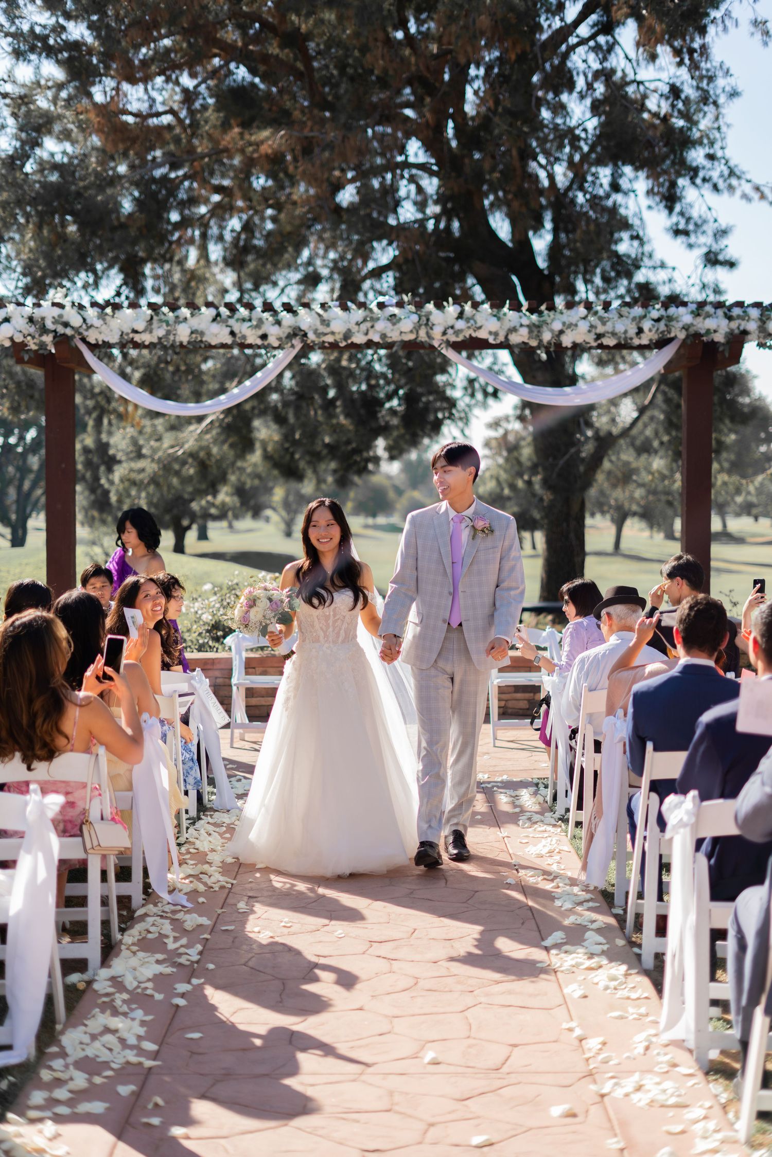 Bride and groom officially married, walking down the aisle together in joy.