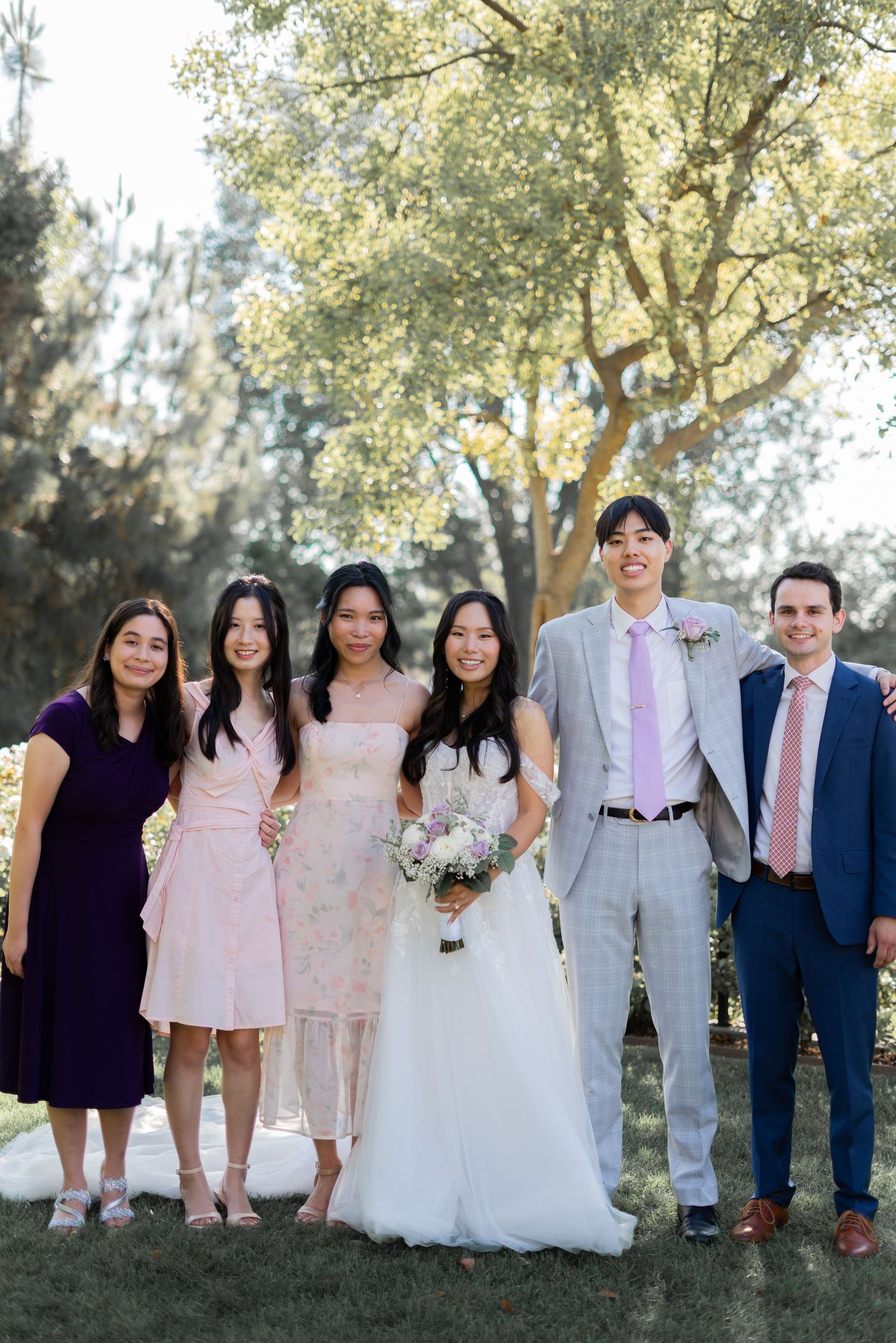 Bride and groom capturing joyful moments with their loved ones in photos.