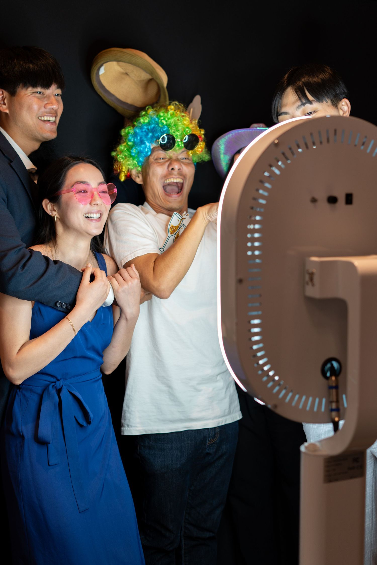 Many wedding guests having fun in the photo booth during the reception