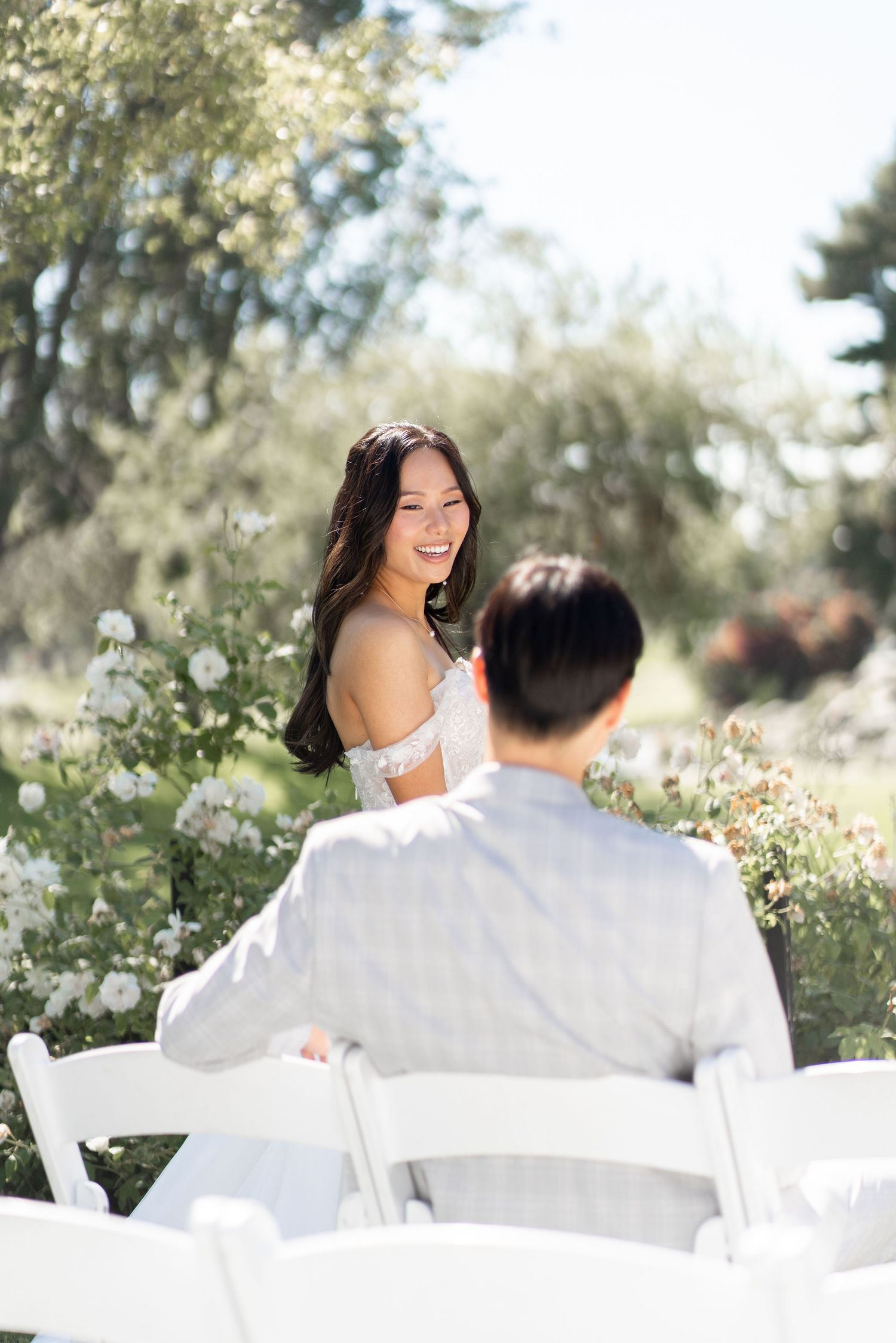 Bride and groom capturing sweet moments in photos before the ceremony begins.