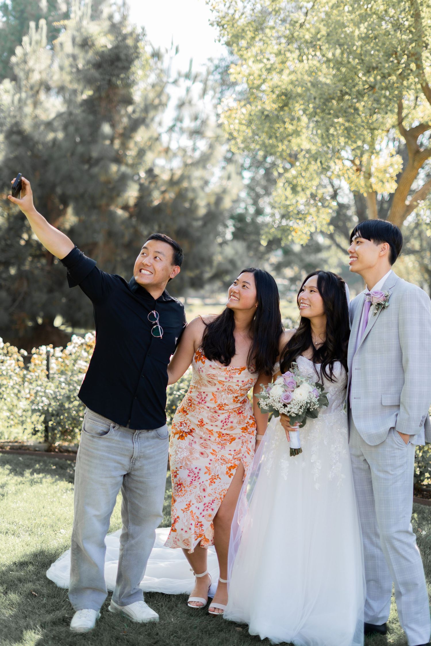 Bride and groom capturing joyful moments with their loved ones in photos.