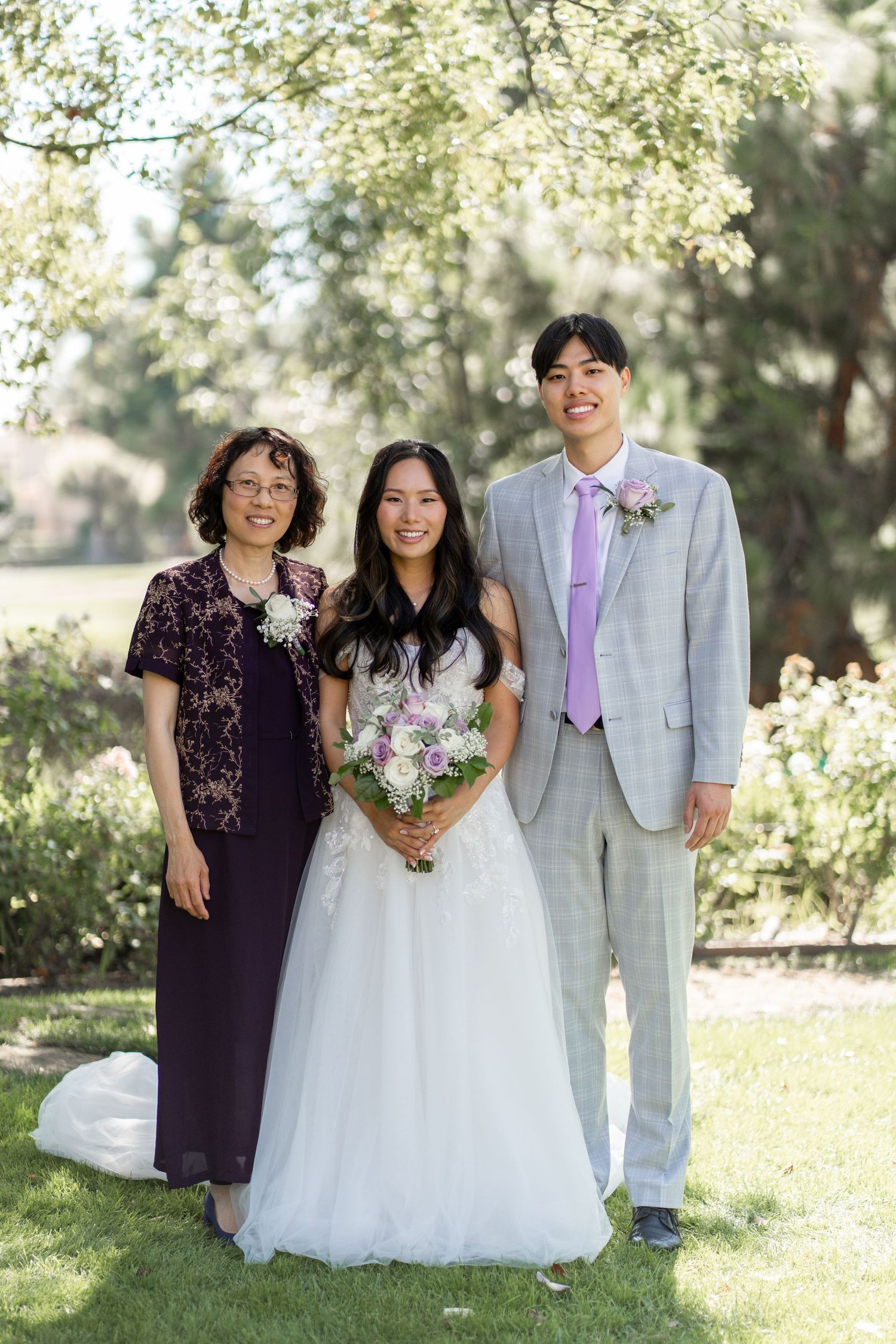 Bride and groom capturing cherished family photos surrounded by their loving relatives.