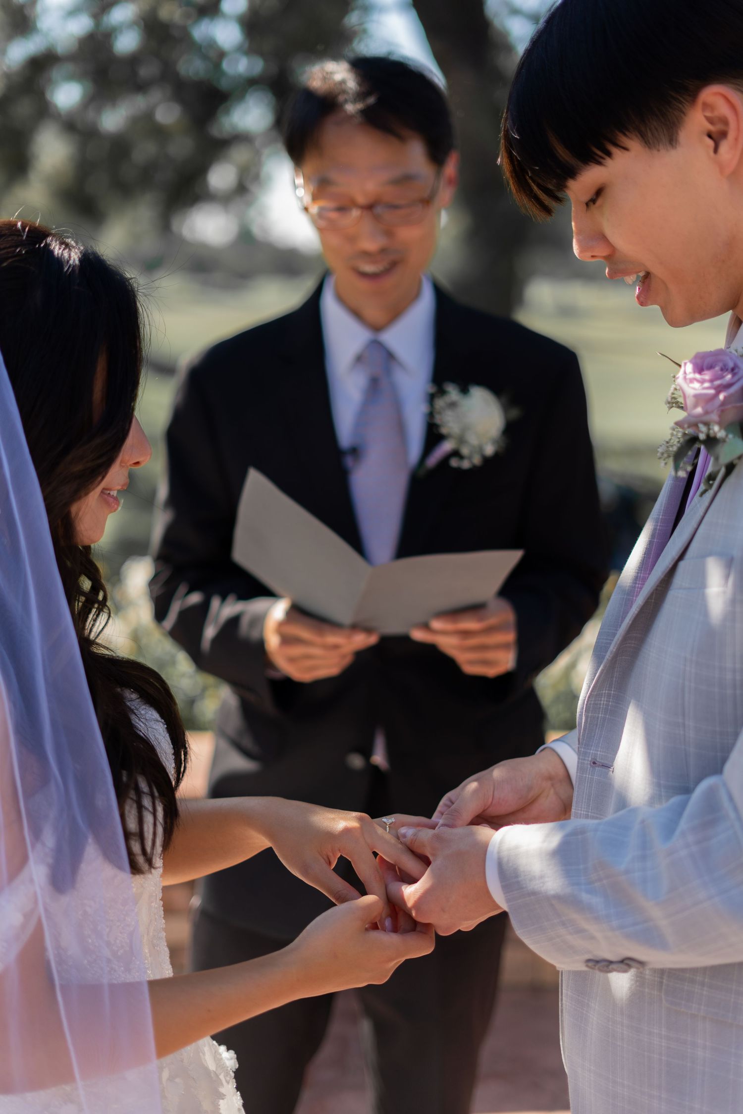 Bride and groom exchanging rings, a beautiful moment in their wedding ceremony.