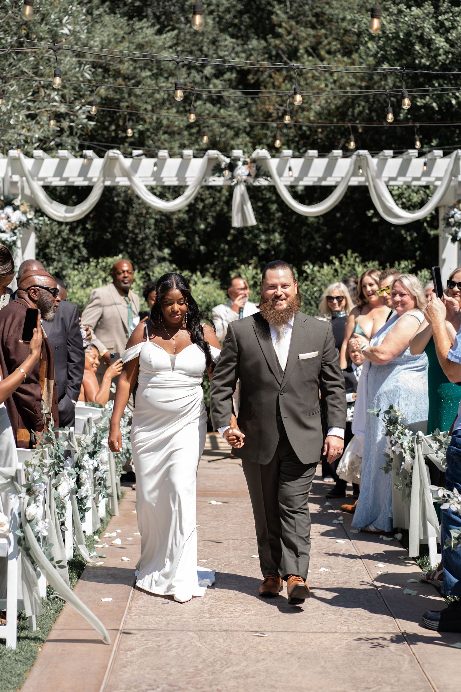 Just married! Bride and groom exit the aisle beaming with joy and love. #JustMarried #WeddingAisleExit
