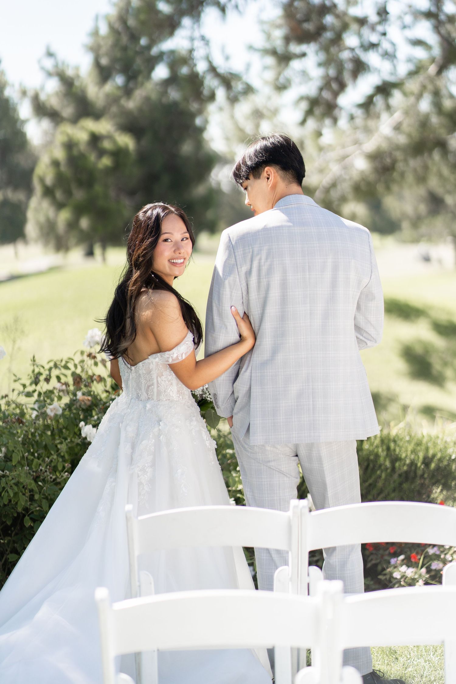 Bride and groom capturing sweet moments in photos before the ceremony begins.