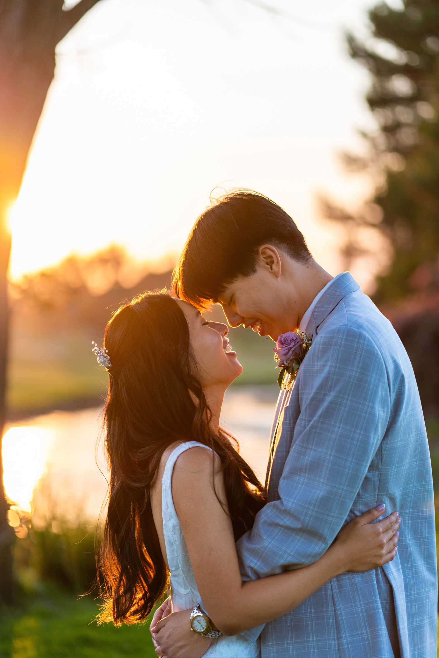 Bride and groom sharing a romantic couples photoshoot under a golden sunset.