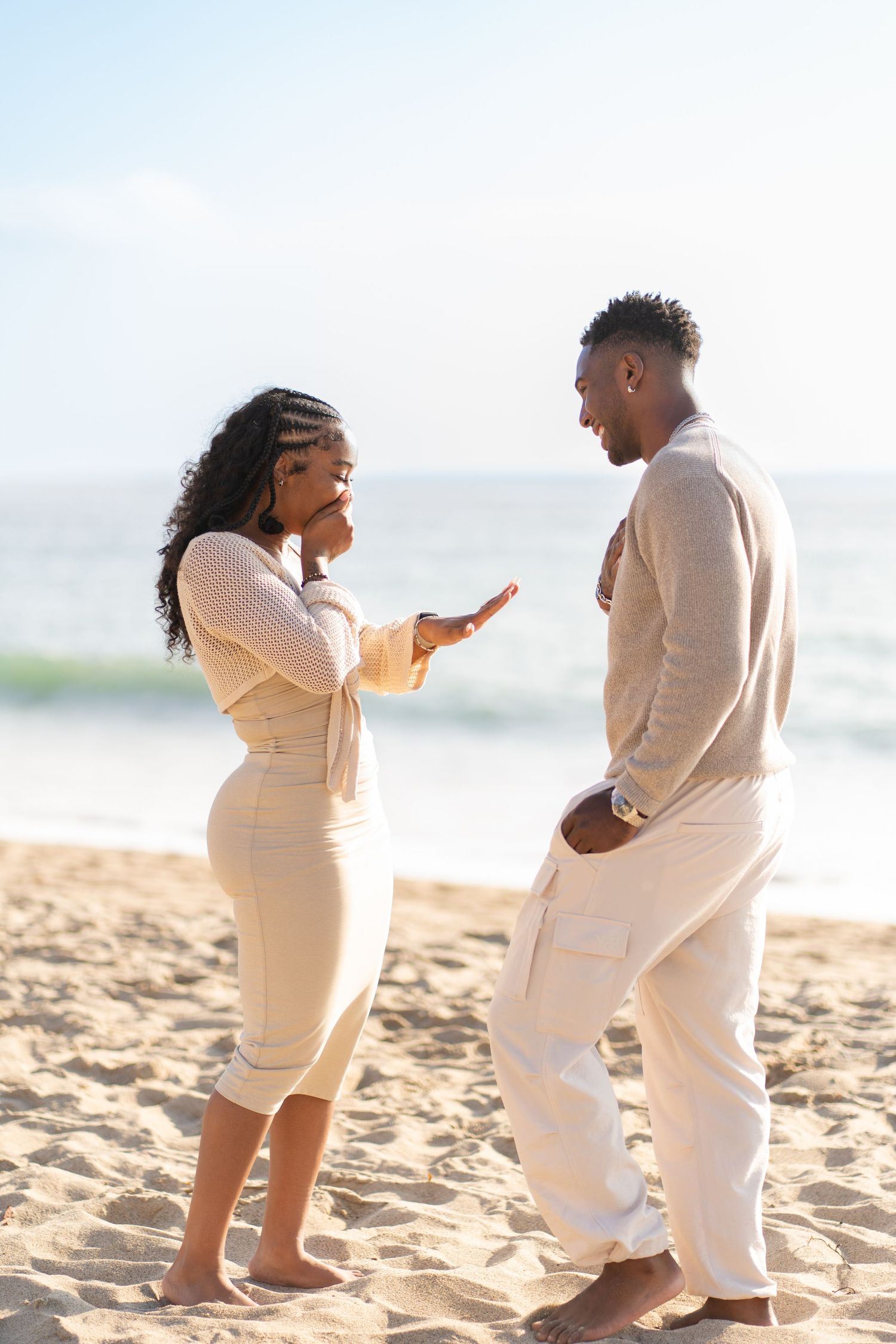 Romantic couple enjoying their engagement at Point Dume Beach, capturing love, ocean views, and golden California coastal vibes.