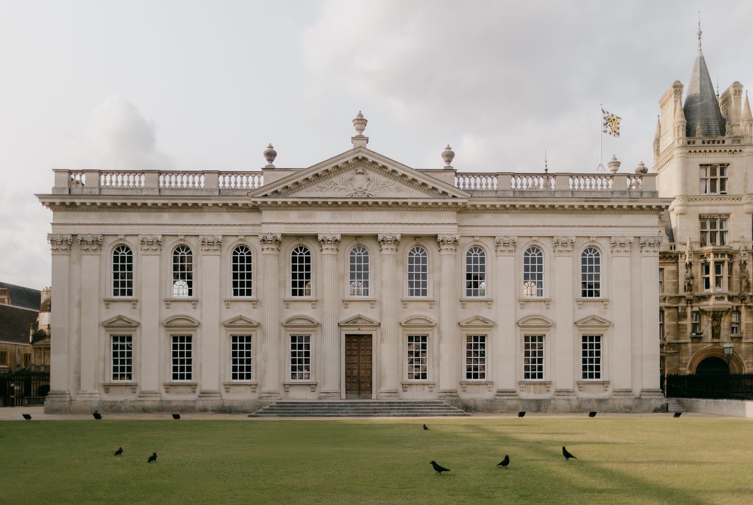 A panoramic view of a historic white Georgian building with symmetrical windows and architectural details.