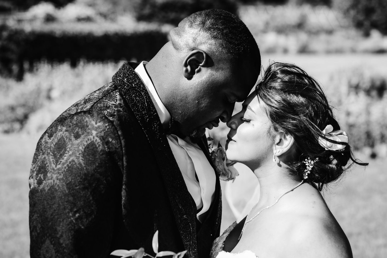 Intimate black and white wedding portrait capturing a tender moment.