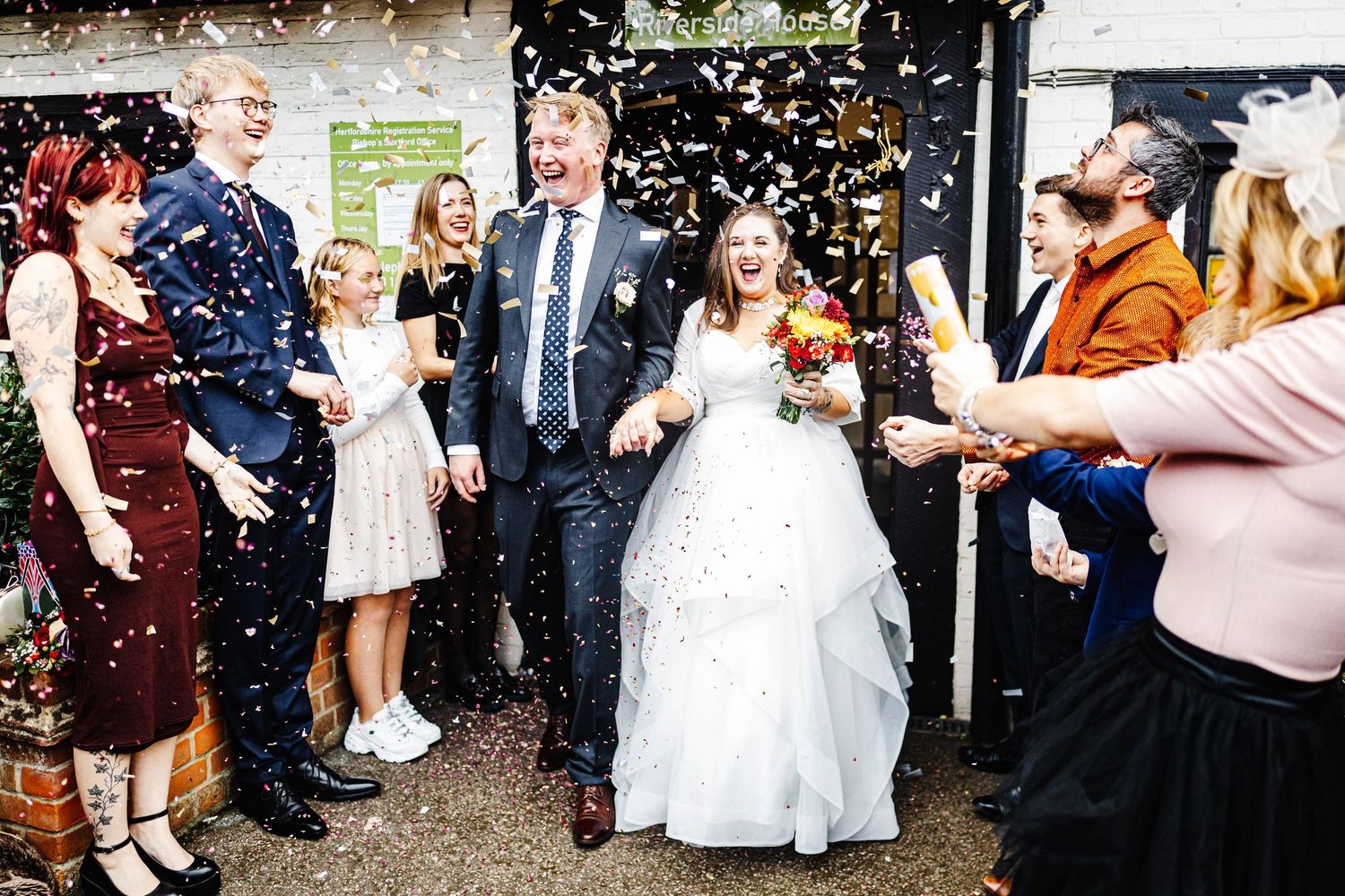Wedding guests shower the couple with confetti on their special day.