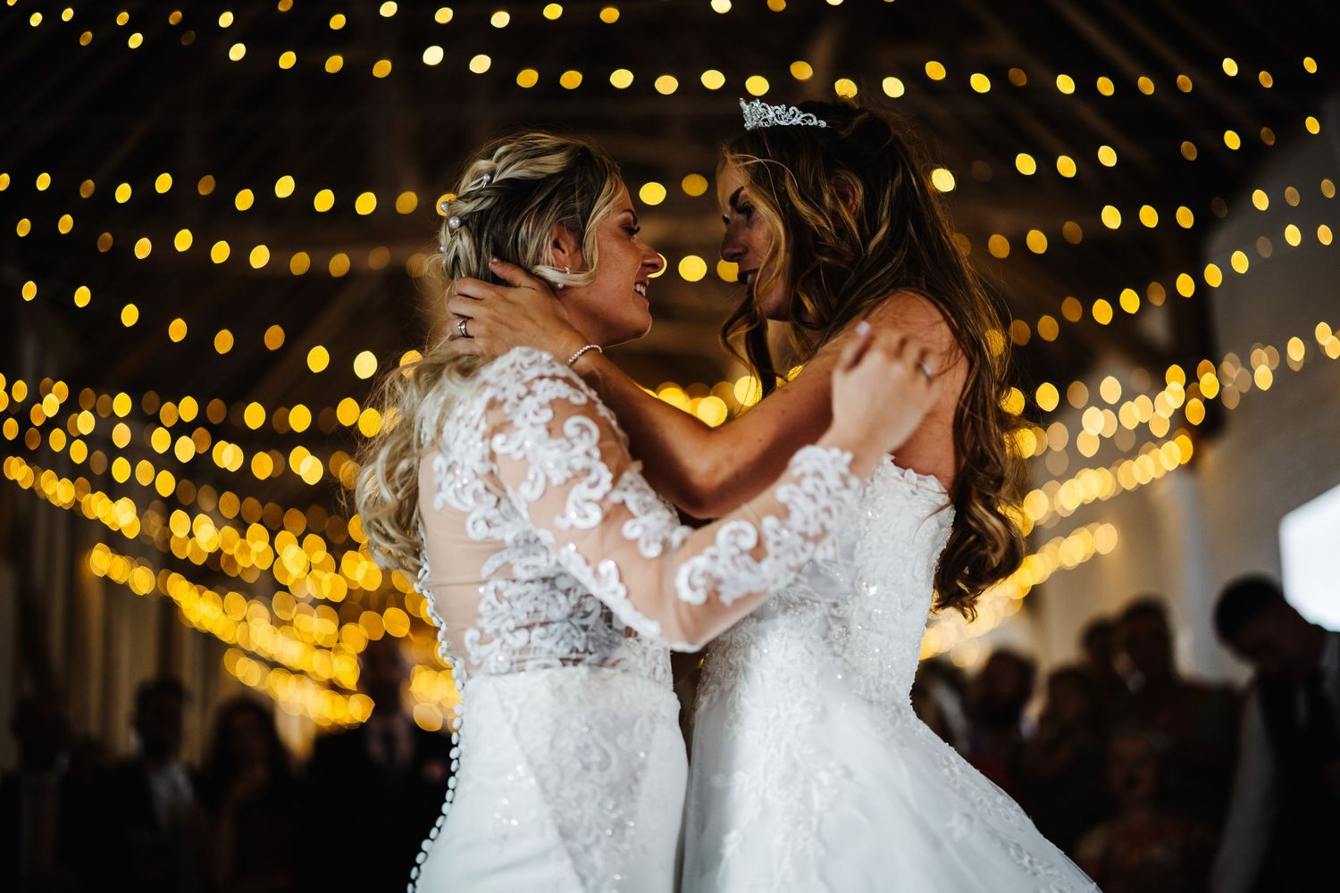 Wedding reception dance under warm string lights creating romantic ambiance.