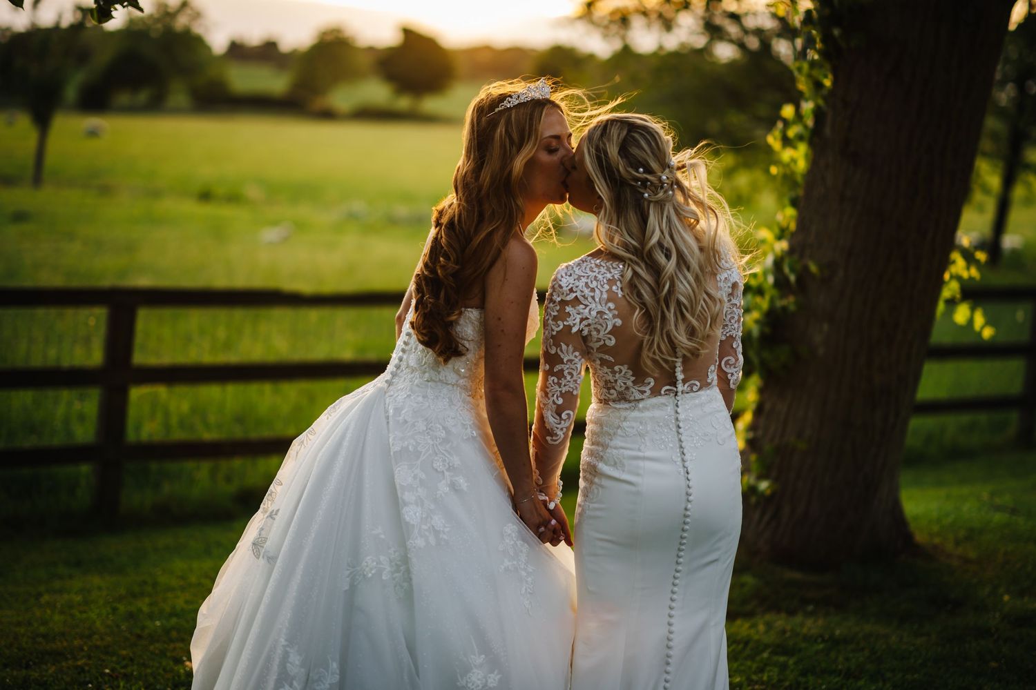 Beautiful sunset wedding photography session in a lush green field.