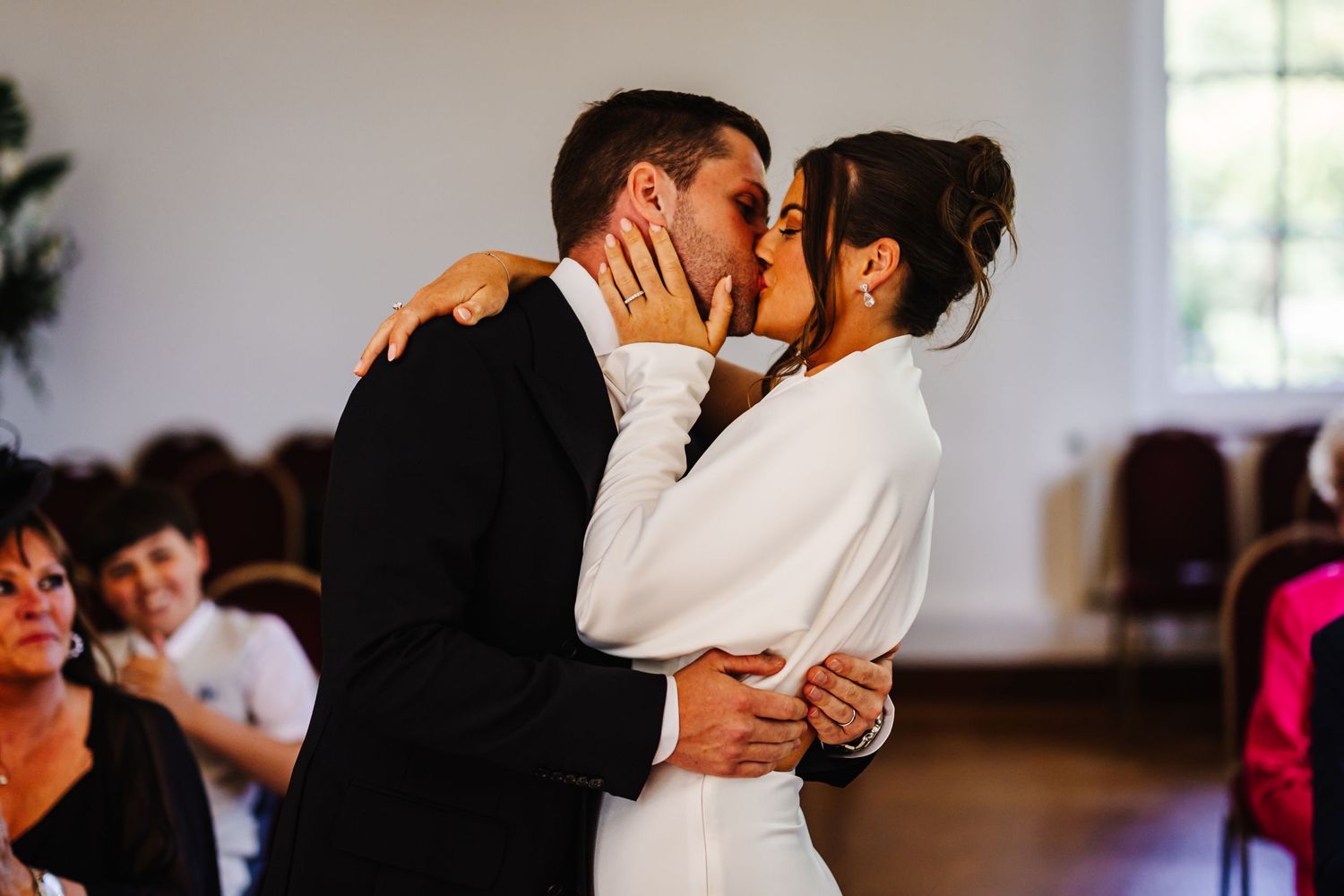 First dance moment at indoor wedding reception with romantic lighting.