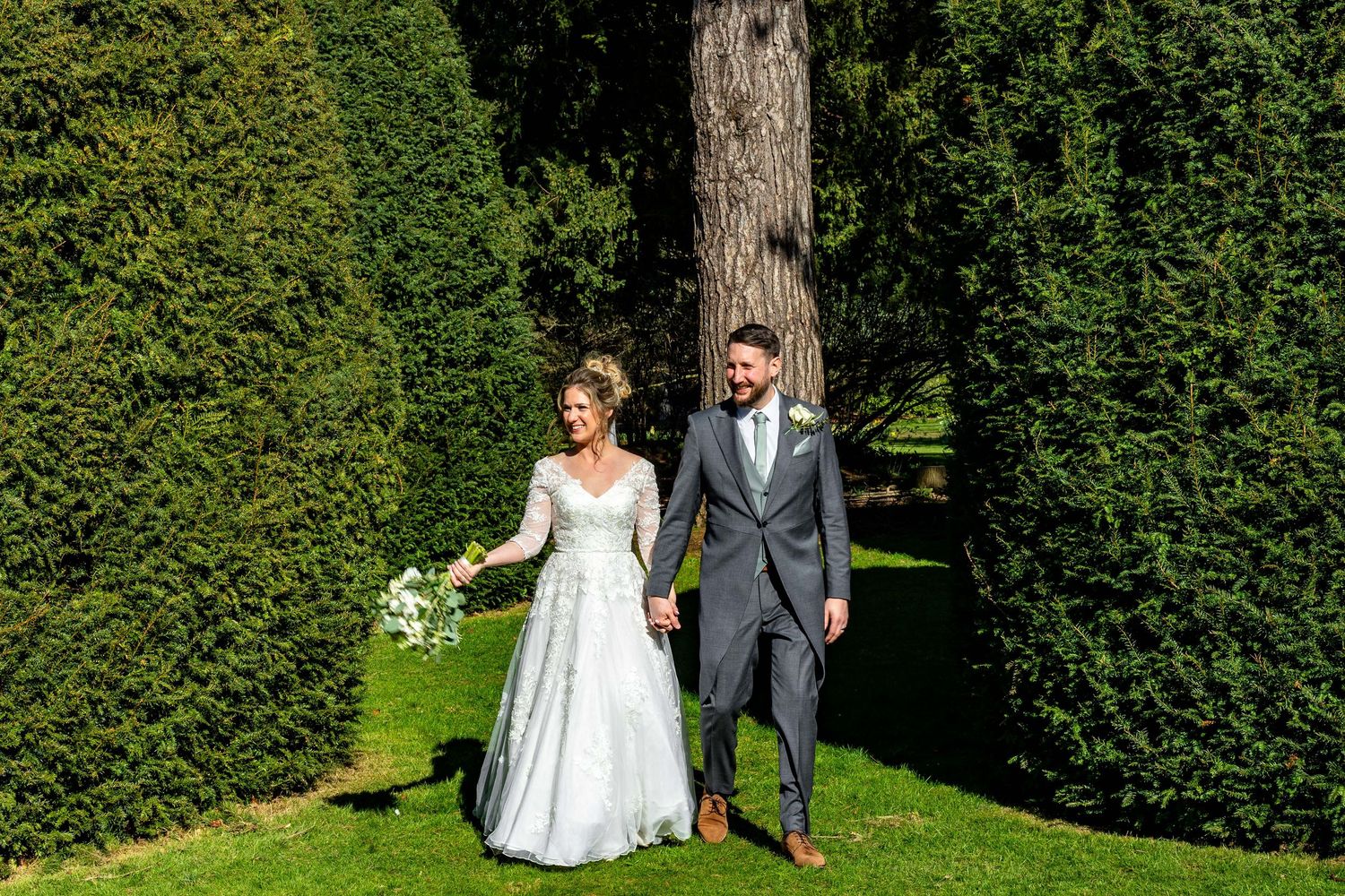 Romantic garden wedding photoshoot with elegant landscaping and greenery.