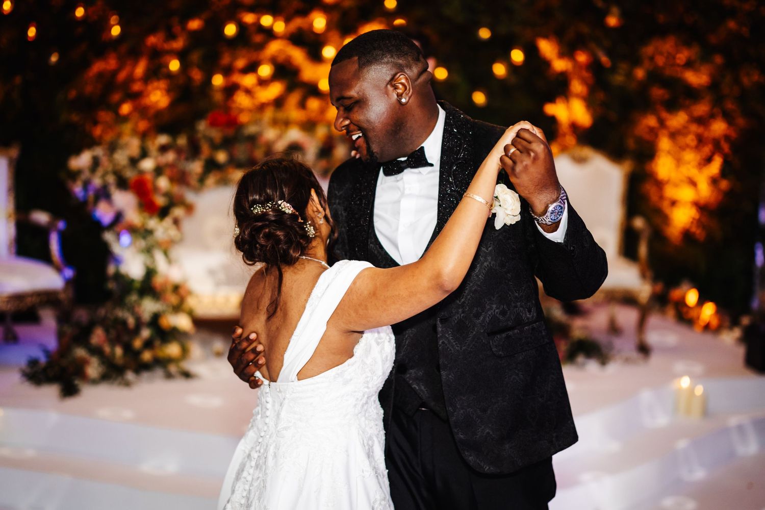 Couples dancing at an elegant evening reception with warm ambient lighting and autumn decor.